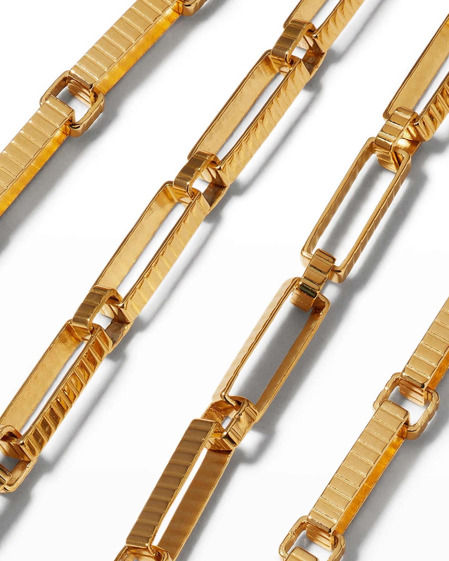 A close of up of the gold-plated Signora Chain choker necklace with rectangular links, displayed on a white background.