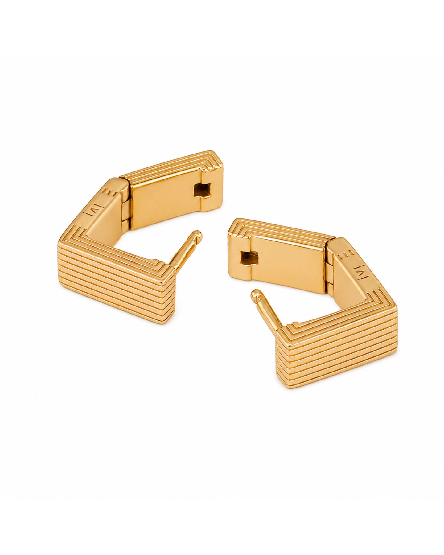 Gold cufflinks on a white background