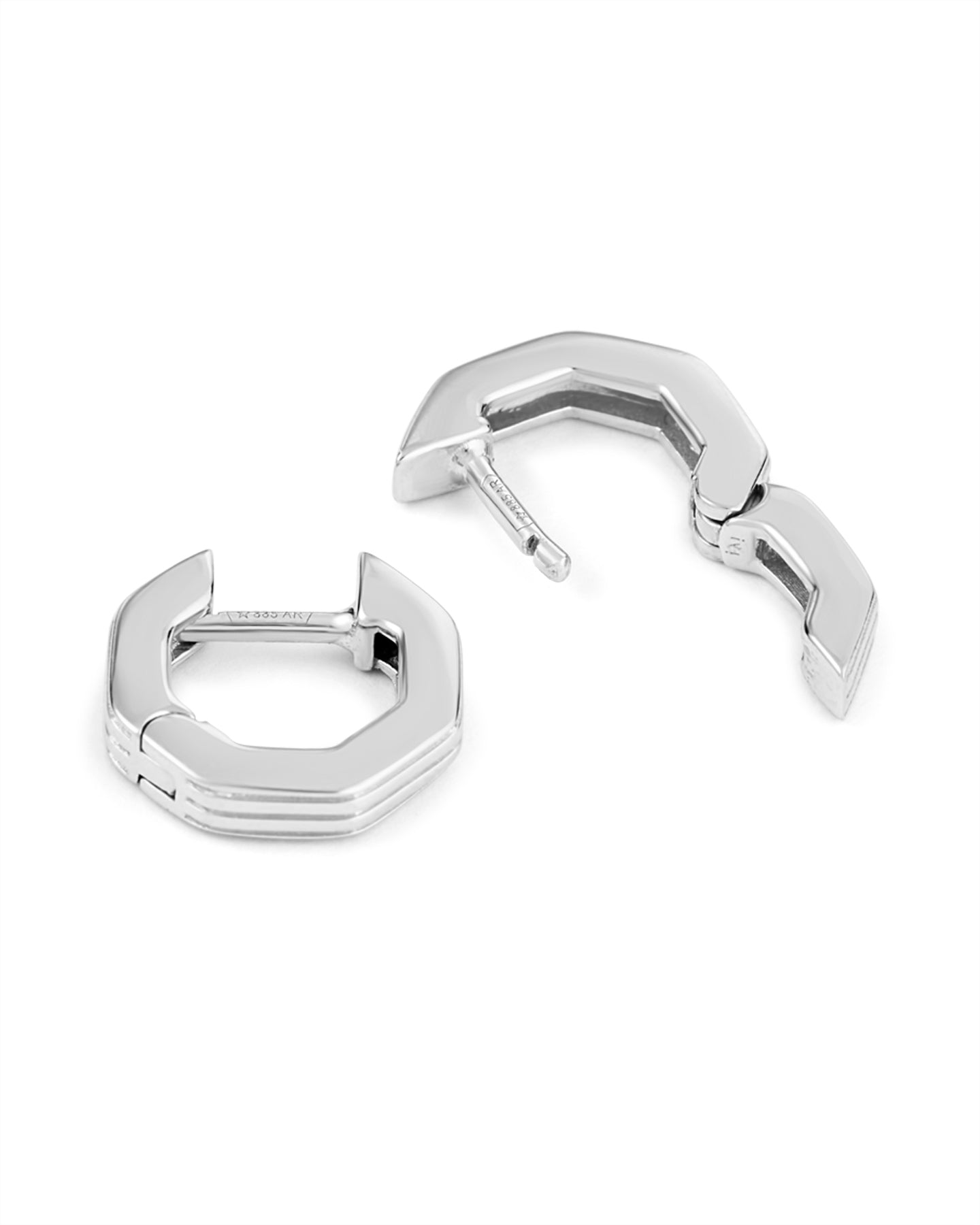 Silver geometric huggies earrings with angular design.