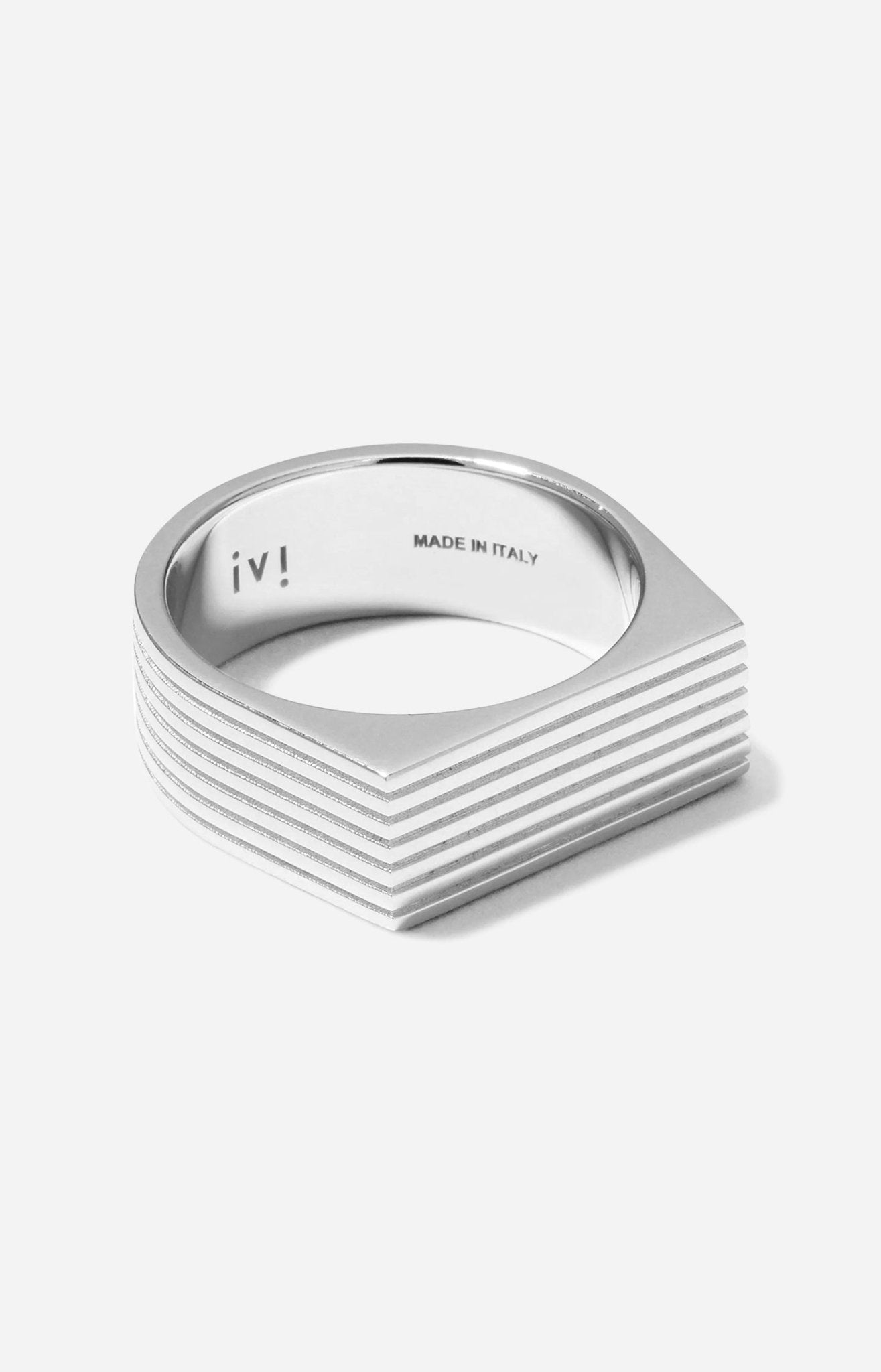 A rhodium-plated silver signet ring with angular proportions, featuring the brand mark 'IVI' on the inside band.
