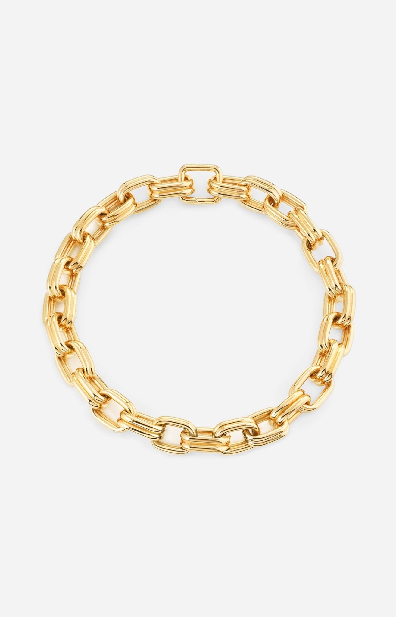 A gold-plated chain necklace with oversized oval links, polished to a high shine, displayed against a white background