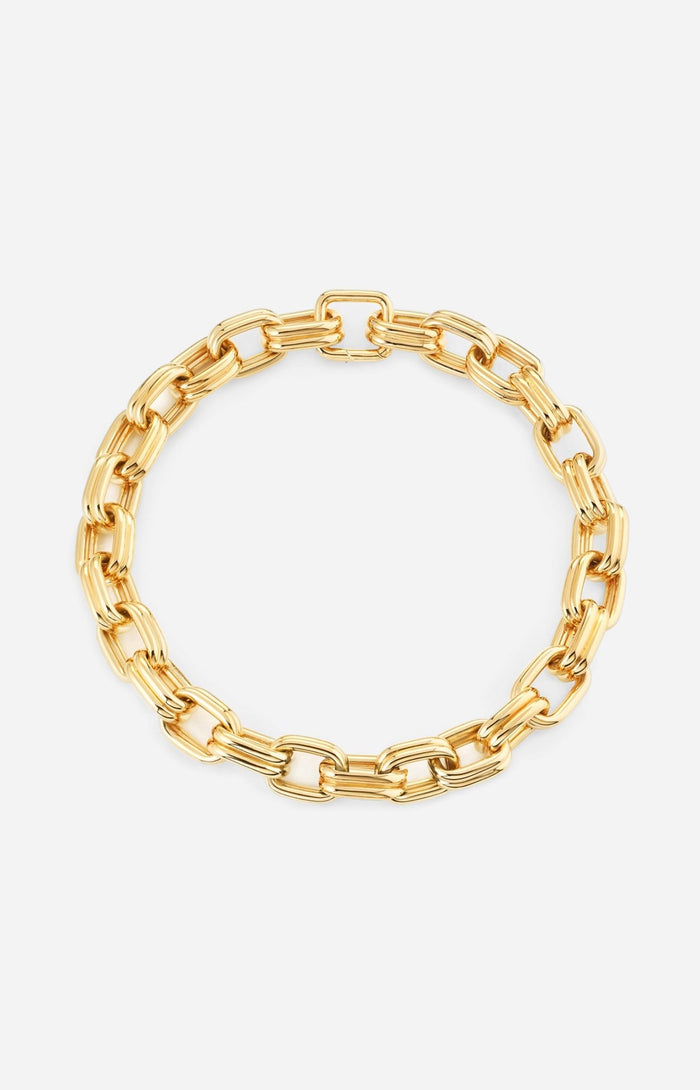 A gold-plated chain necklace with oversized oval links, polished to a high shine, displayed against a white background