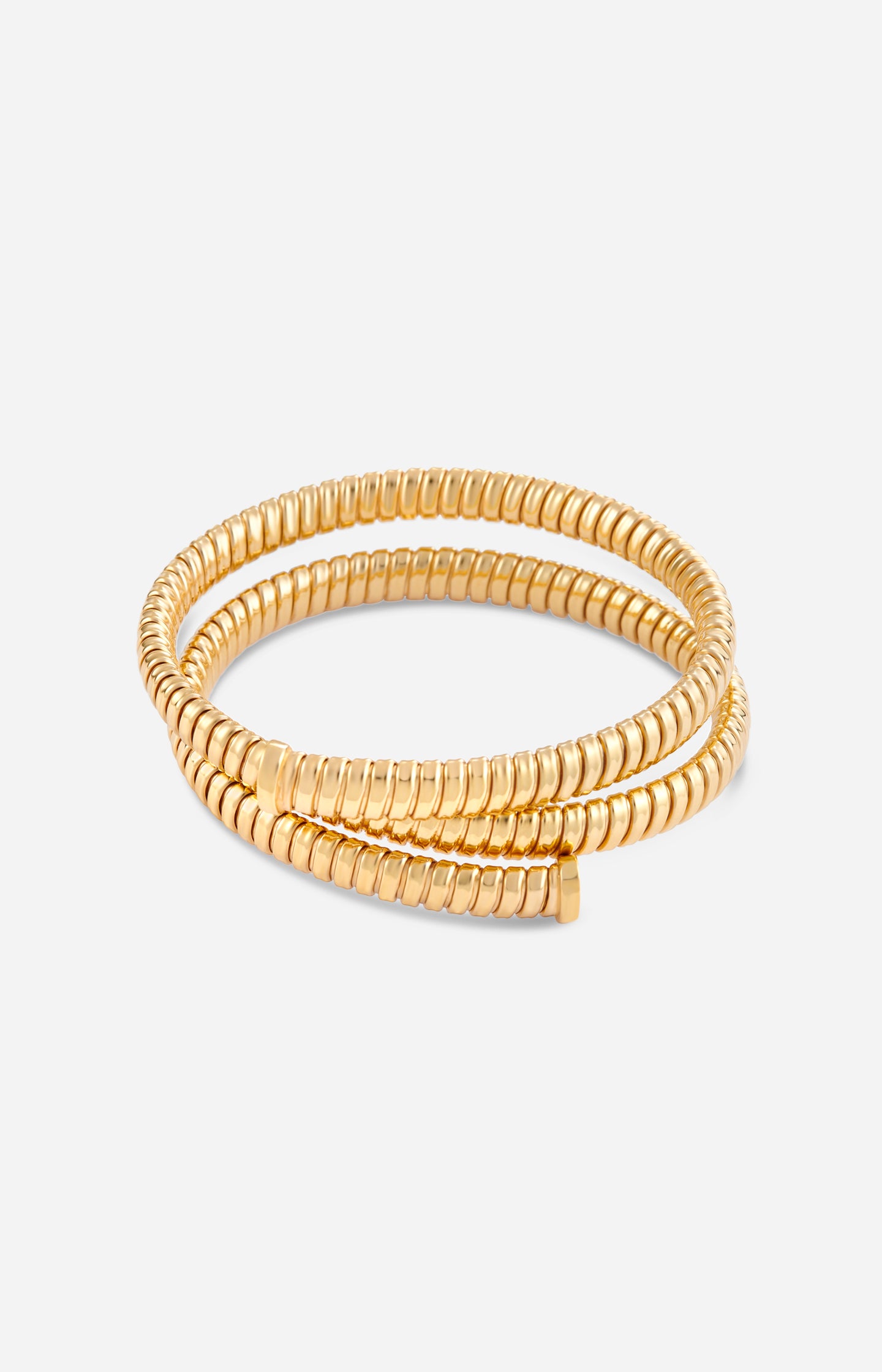 Gold spiral bracelet on a white background