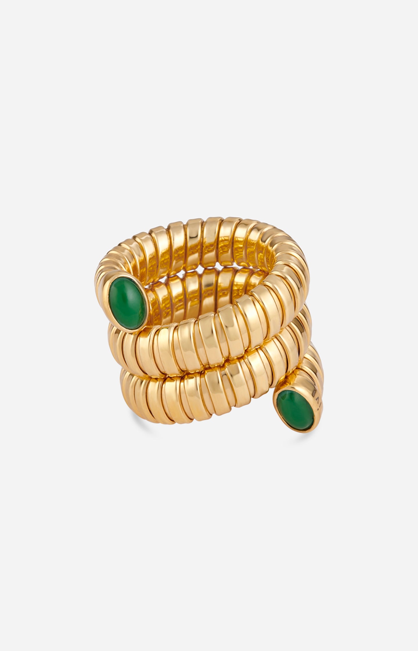 Gold spiral ring with green stones on a white background