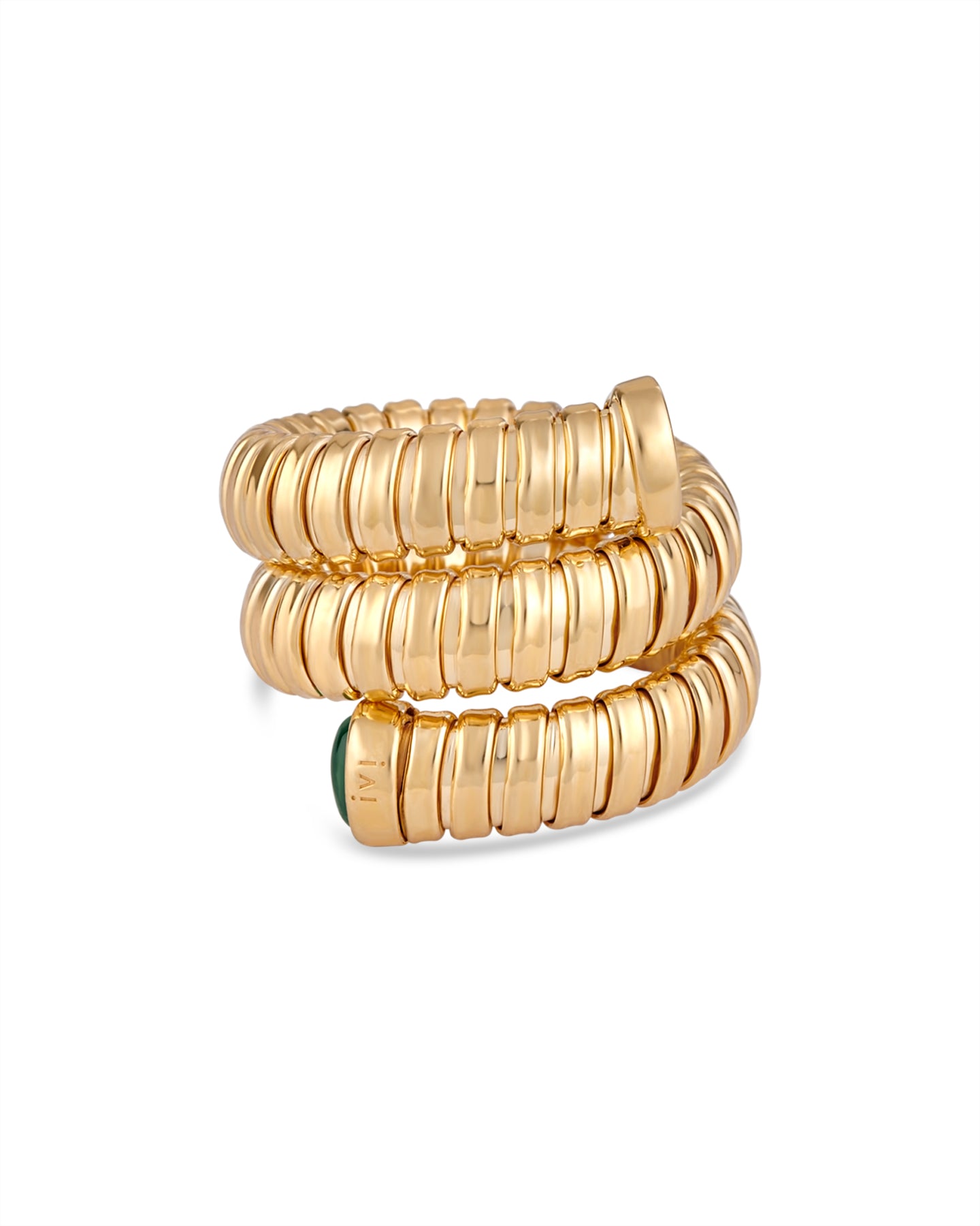 Gold spiral ring with green stones on a white background