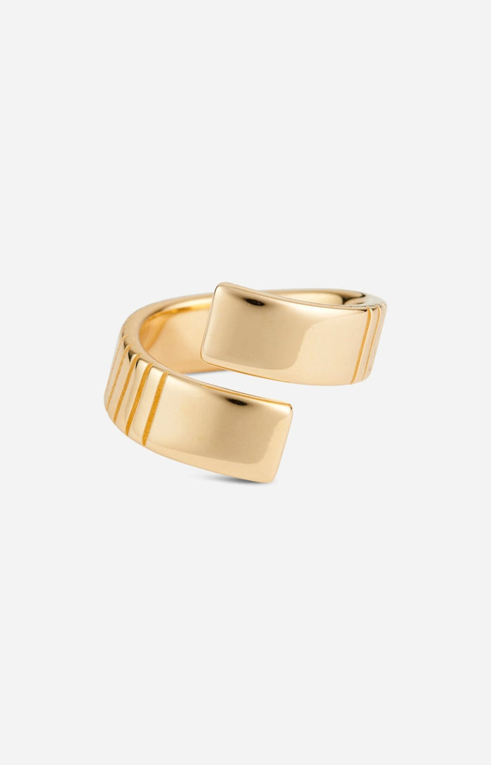 A gold-plated, twist-style ring with a bold aesthetic and meticulous engravings.