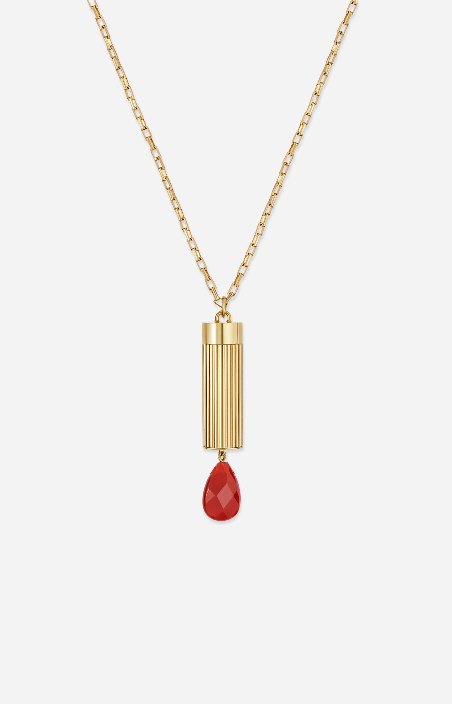 Gold necklace with a red pendant on a white background