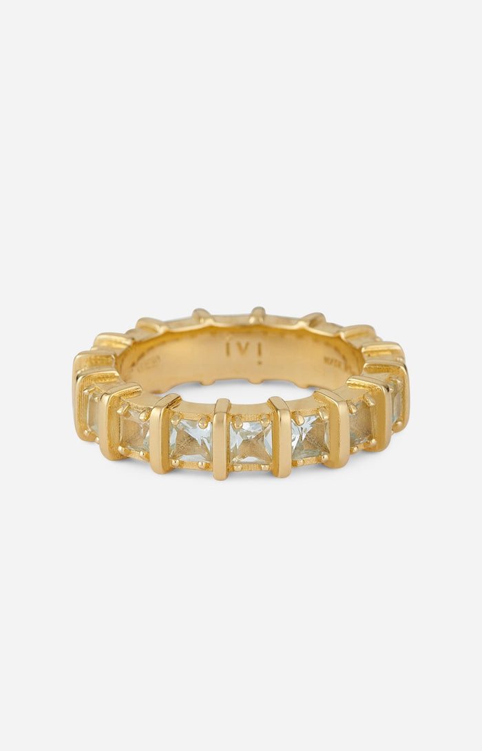 A gold-plated band ring with blue apatite stones set in raised, squared frames