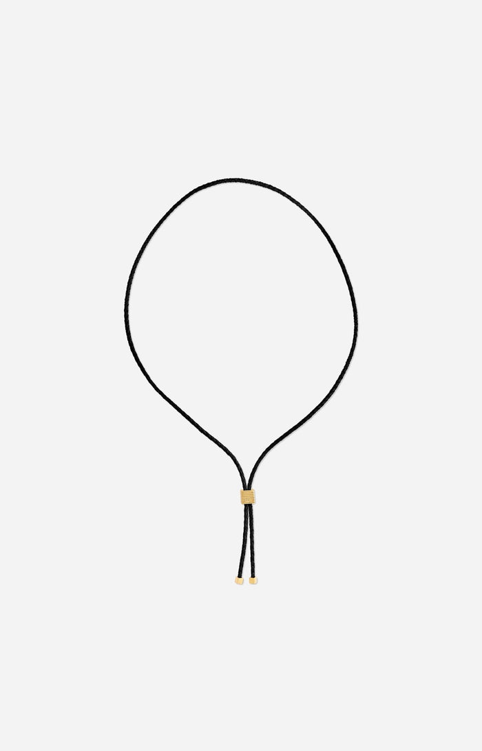 Black adjustable bolo tie necklace with gold slider detail and metal end caps.  