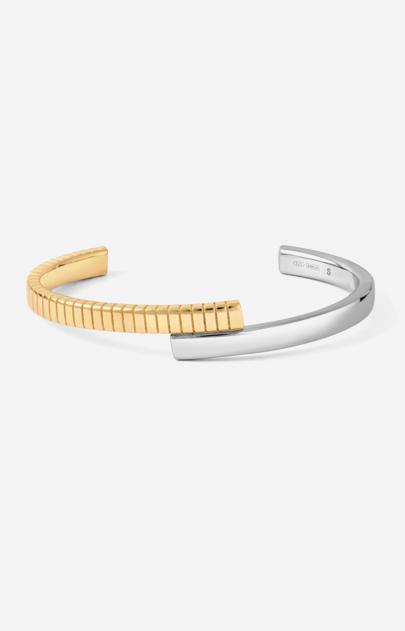 A two-tone (gold and silver) twist cuff bracelet with a mixed-metal finish.