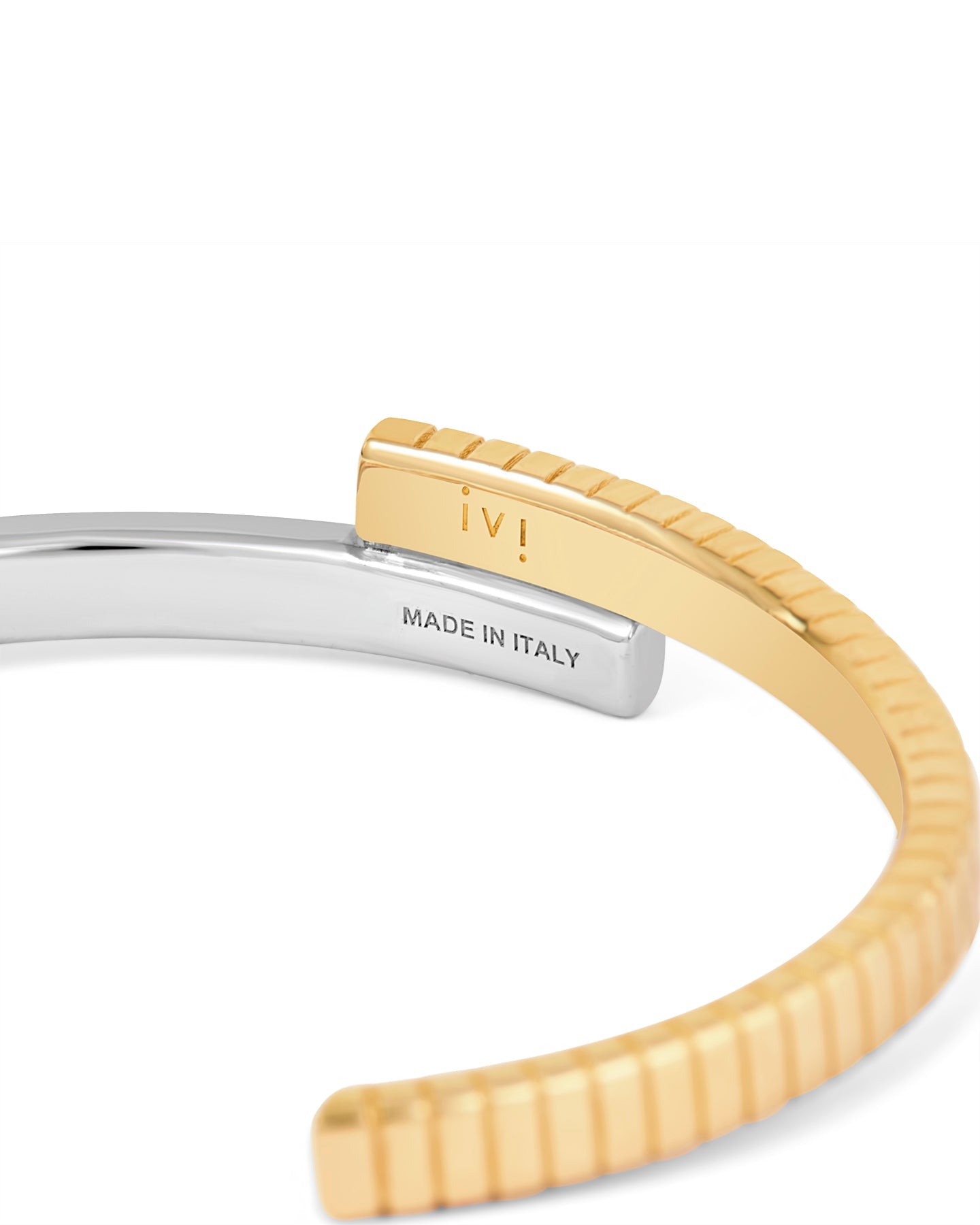 A two-tone (gold and silver) twist cuff bracelet with a mixed-metal finish. 