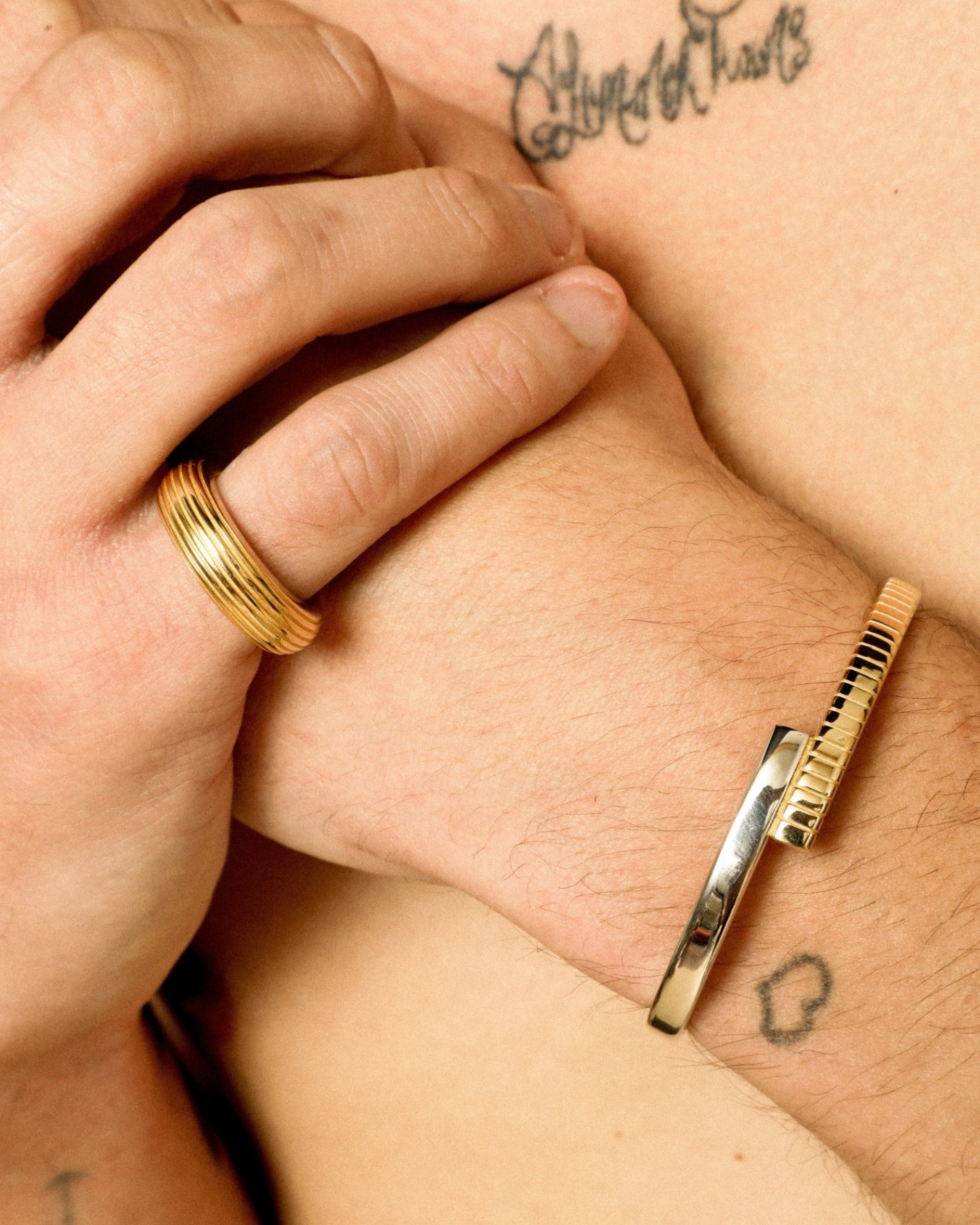 A two-tone (gold and silver) twist cuff bracelet with a mixed-metal finish.