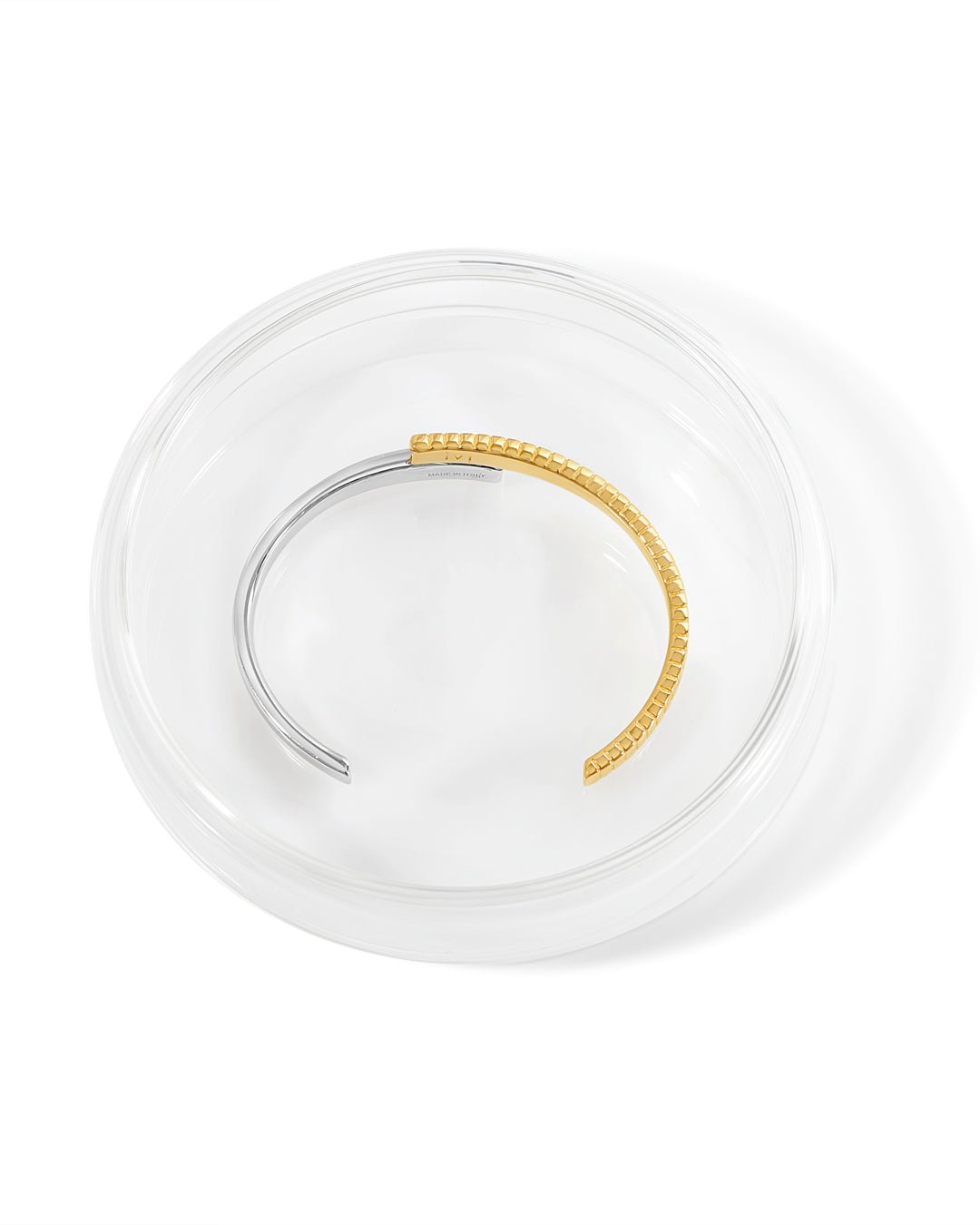 A two-tone (gold and silver) twist cuff bracelet with a mixed-metal finish.