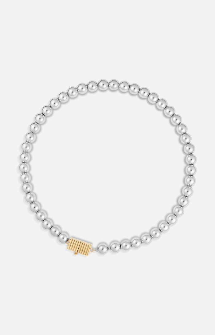 A silver necklace featuring a series of round rhodium-plated beads and a rectangular clasp with a small gold-tone detail.