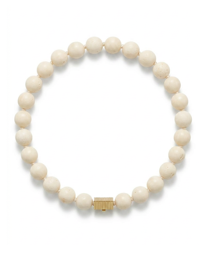 White beaded bracelet with a gold clasp on a white background