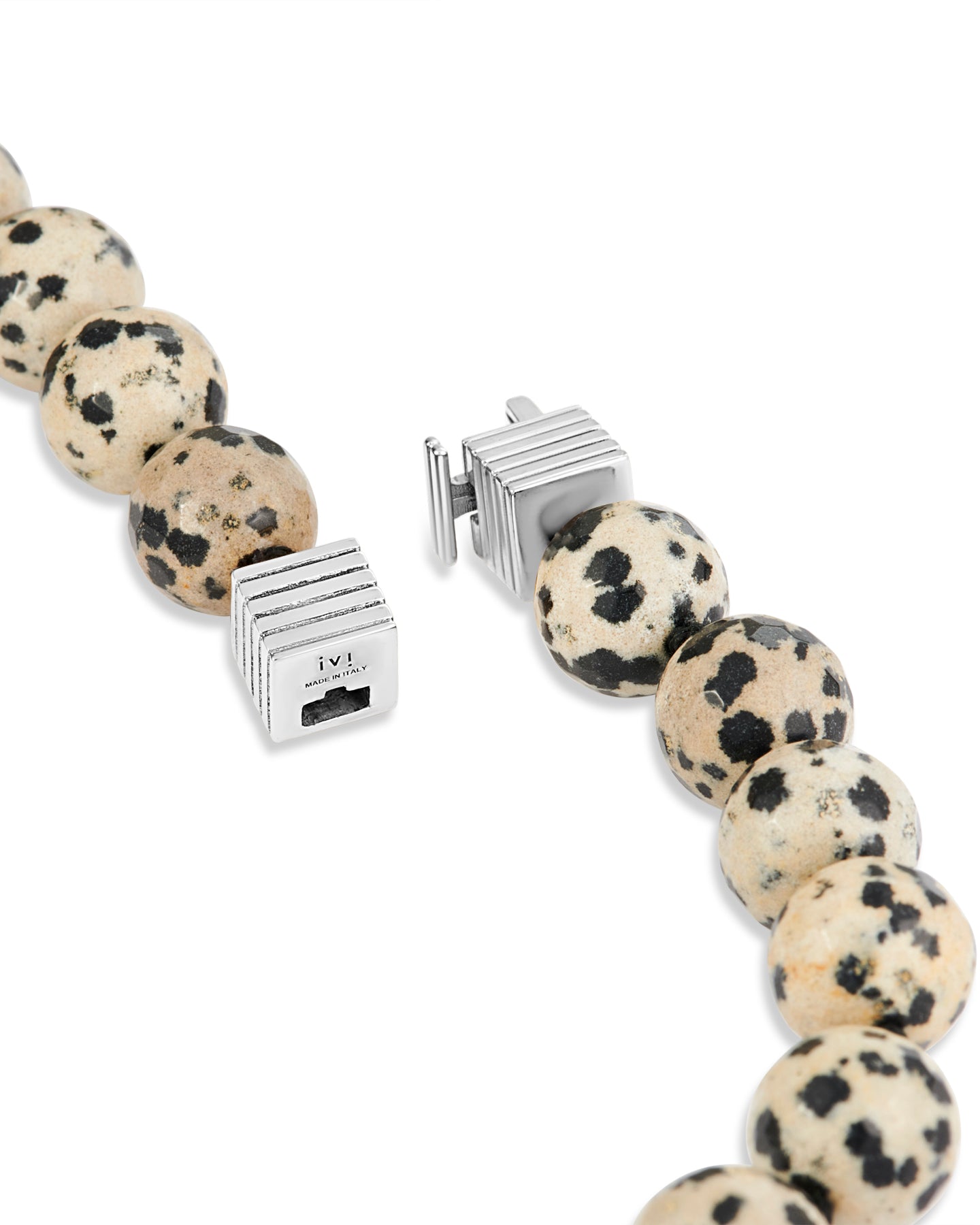 Necklace with dalmatian jasper beads and silver clasp on a white background
