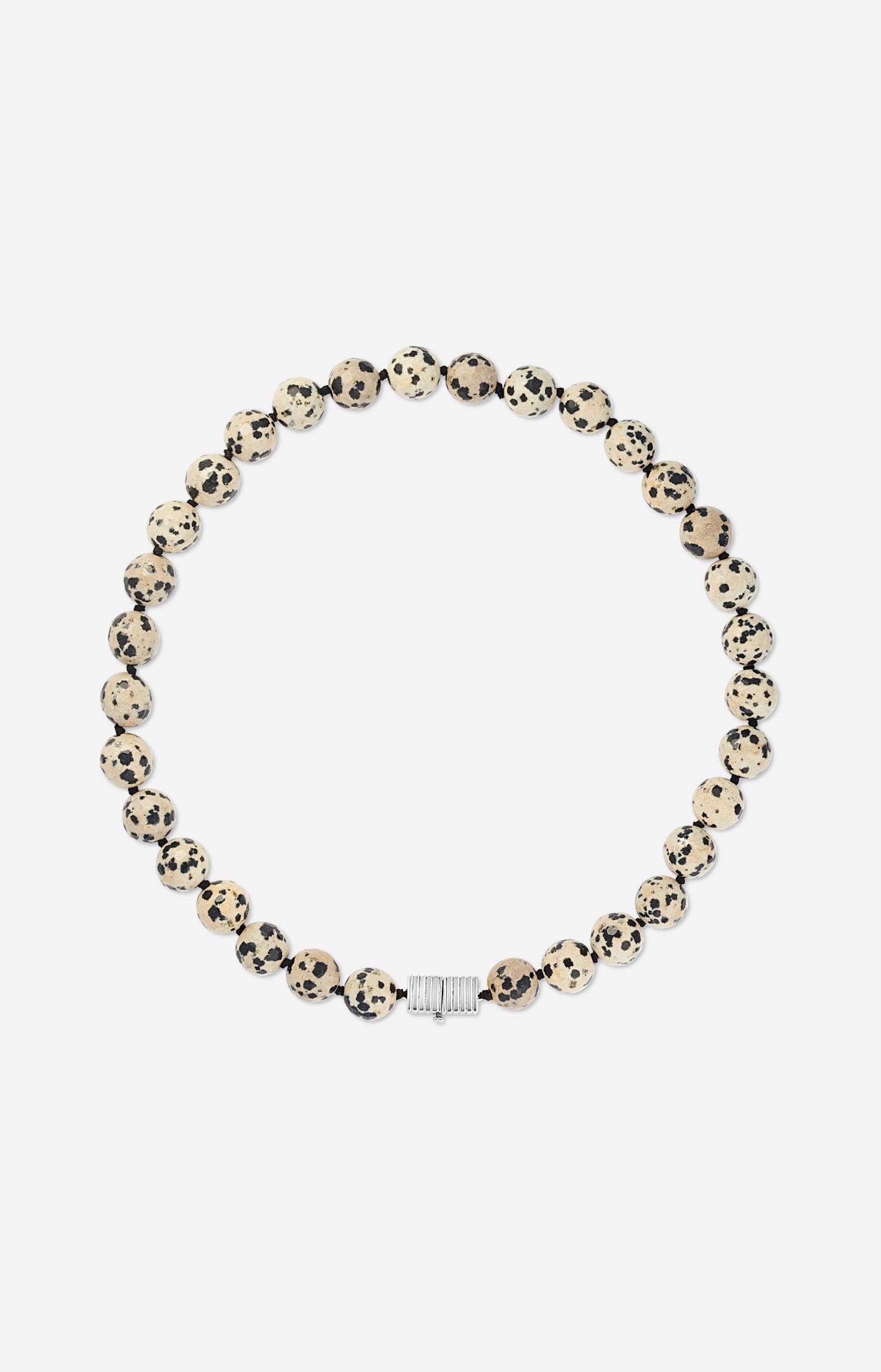 Necklace with dalmatian jasper beads and silver clasp on a white background
