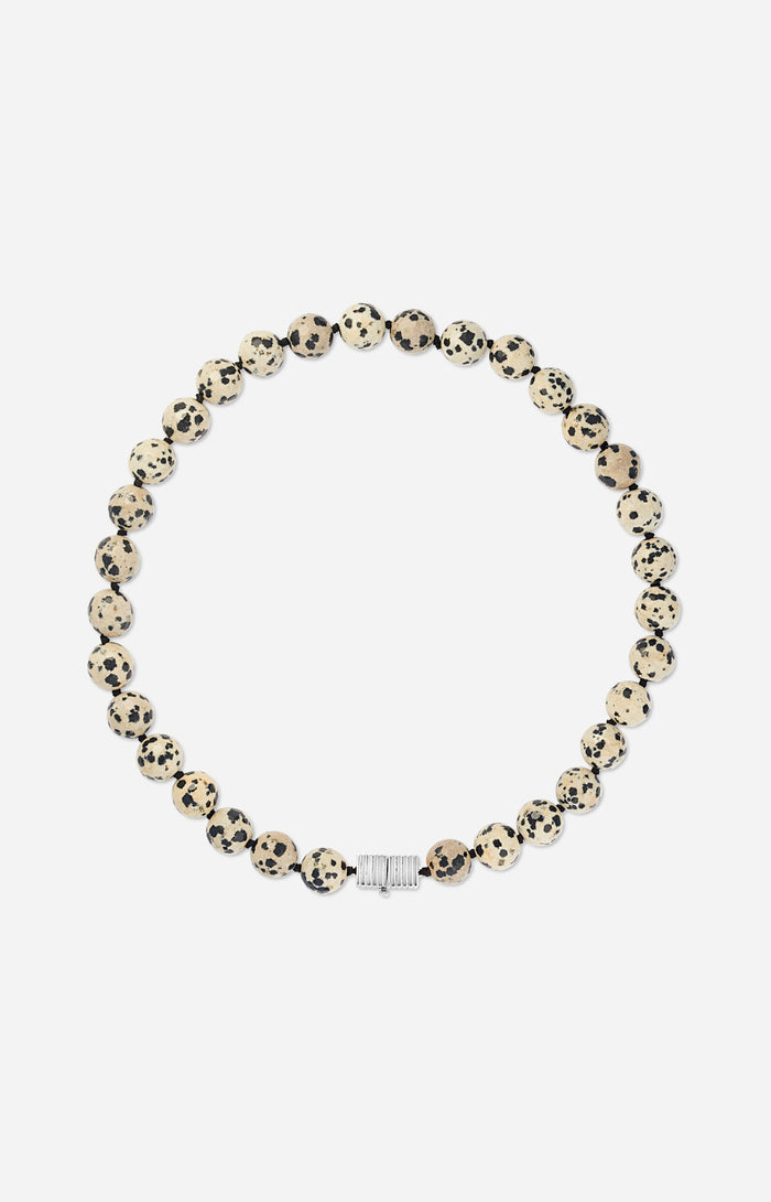 Necklace with dalmatian jasper beads and silver clasp on a white background
