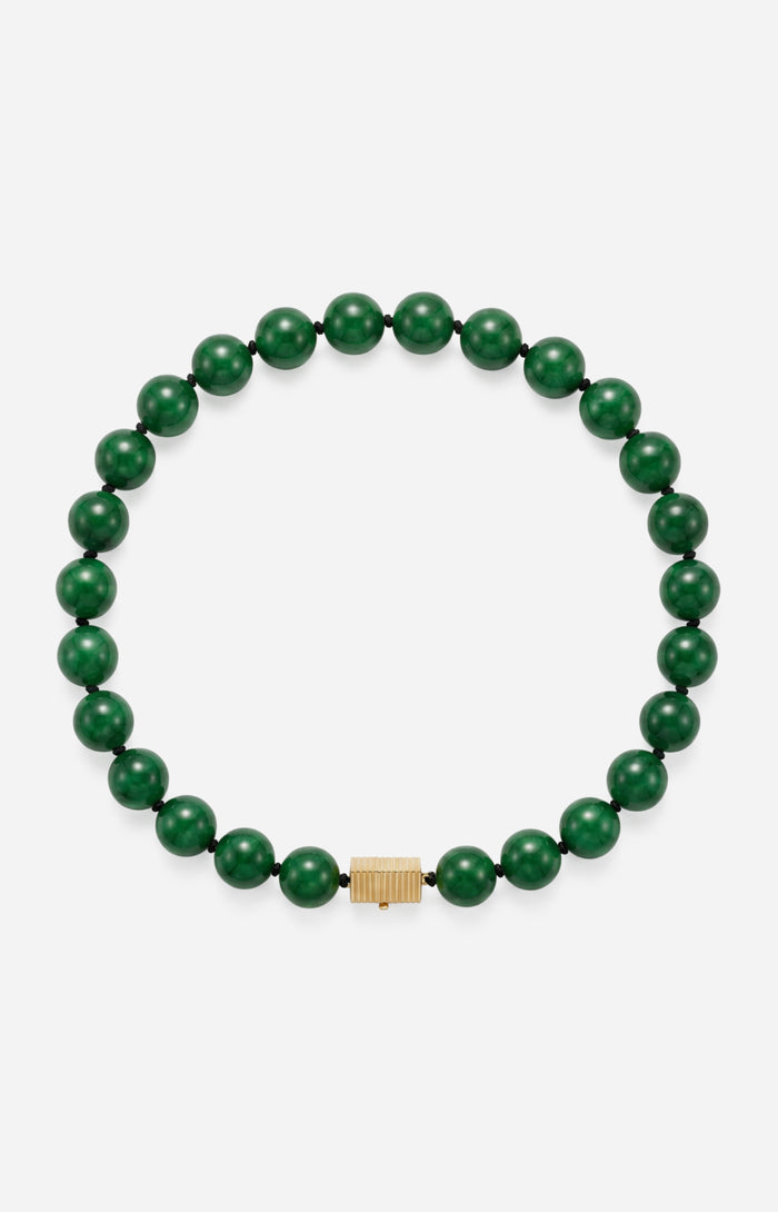 Green beaded bracelet with a gold clasp on a white background