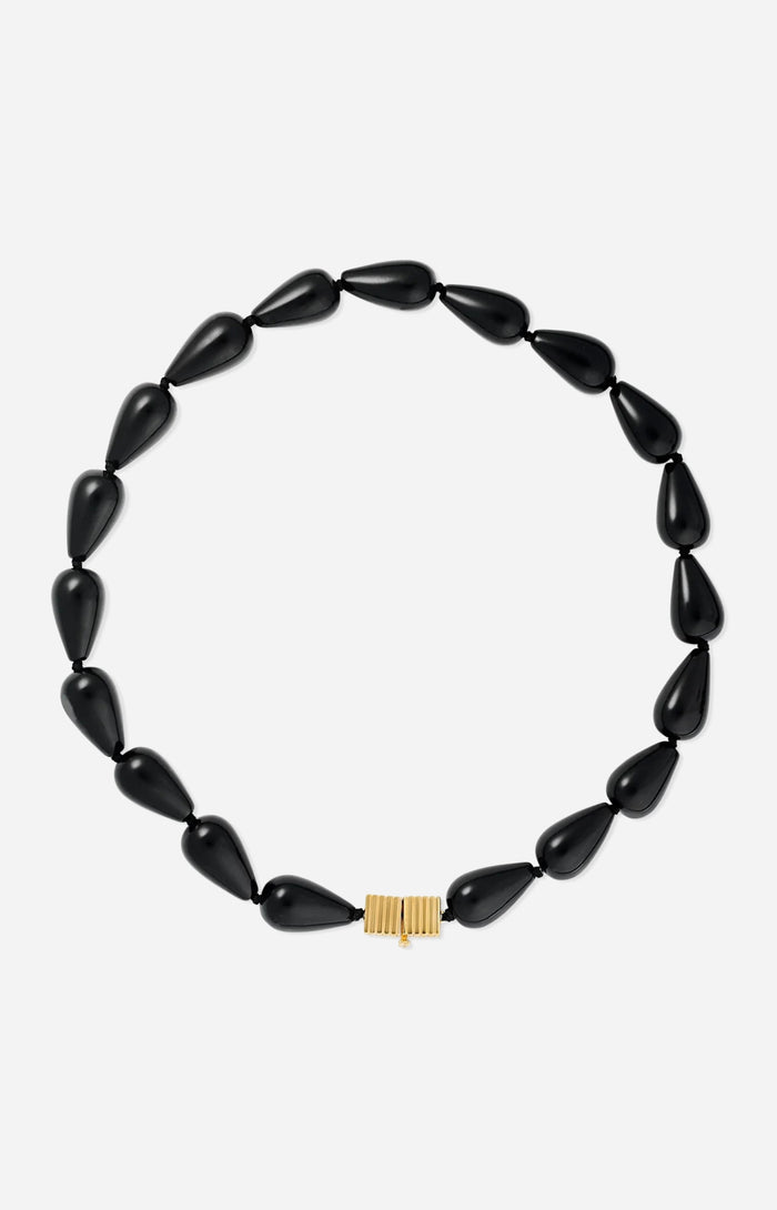 Black teardrop-shaped beaded necklace featuring glossy black beads and a gold clasp, photographed on a white background.