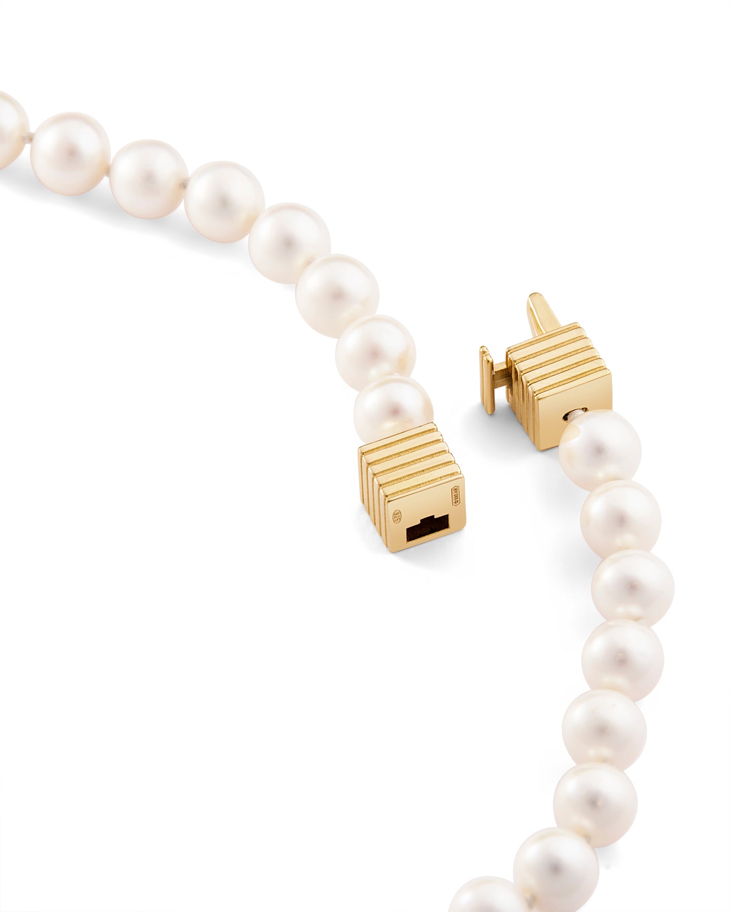 Pearl necklace with a gold clasp on a white background. 