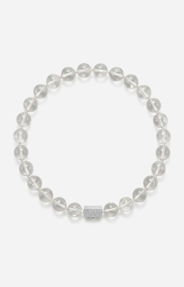 Crystal quartz beaded necklace with a silver clasp on a white background