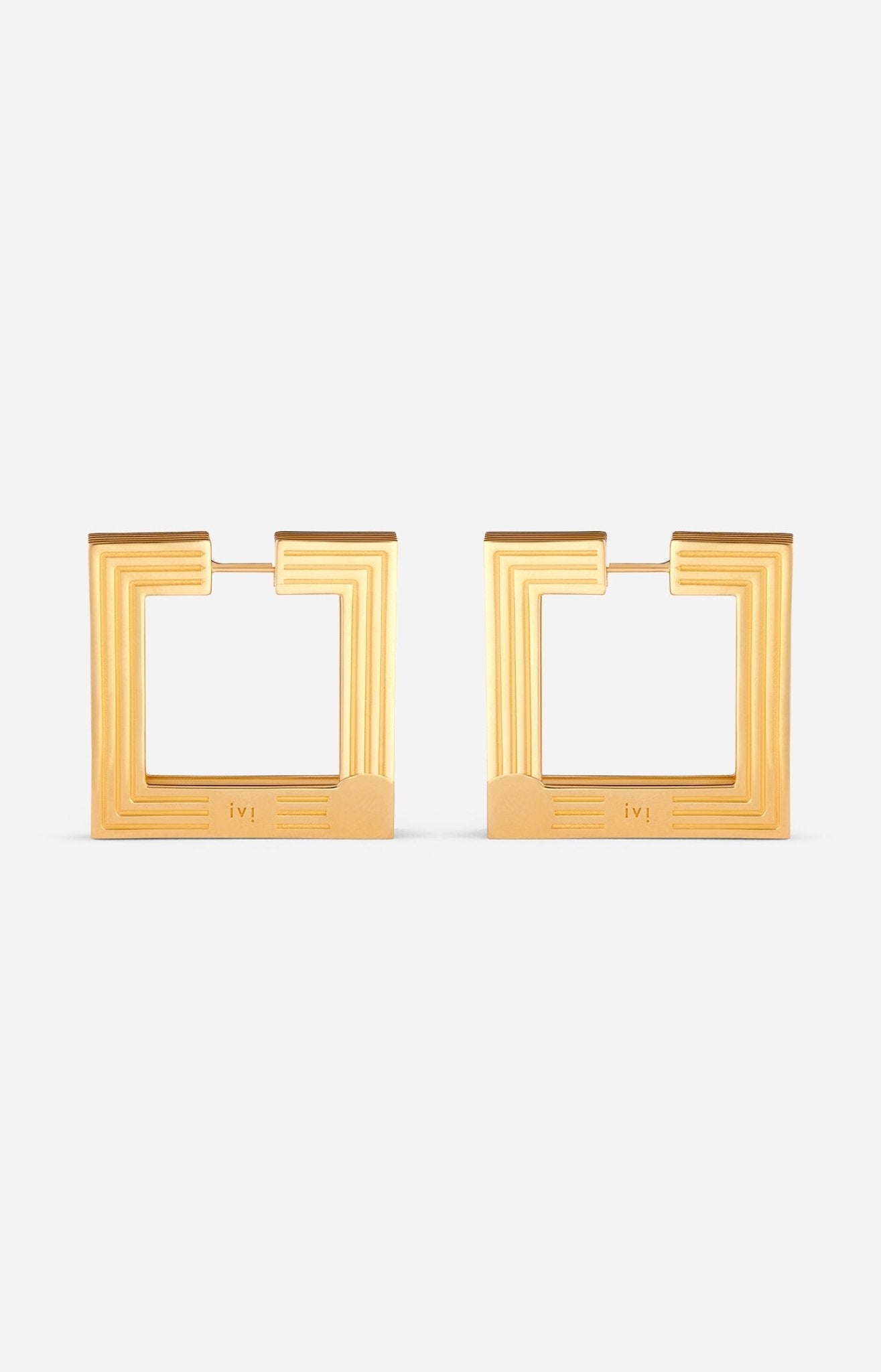Large gold-plated sculptural hoop earrings on a white background.