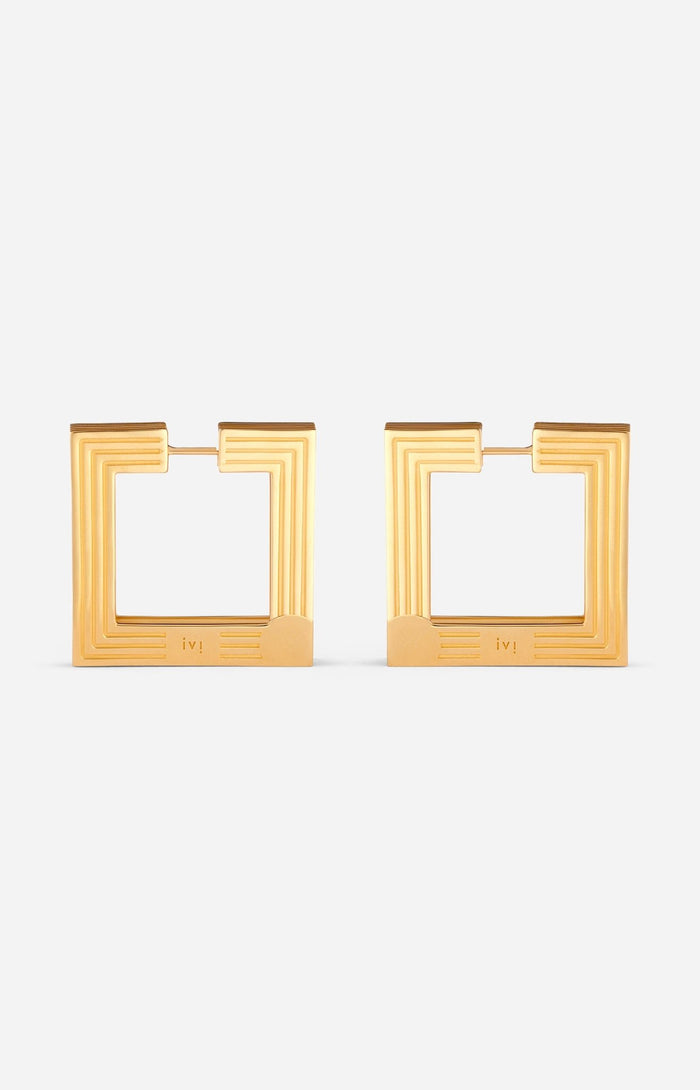 Large gold-plated sculptural hoop earrings on a white background.