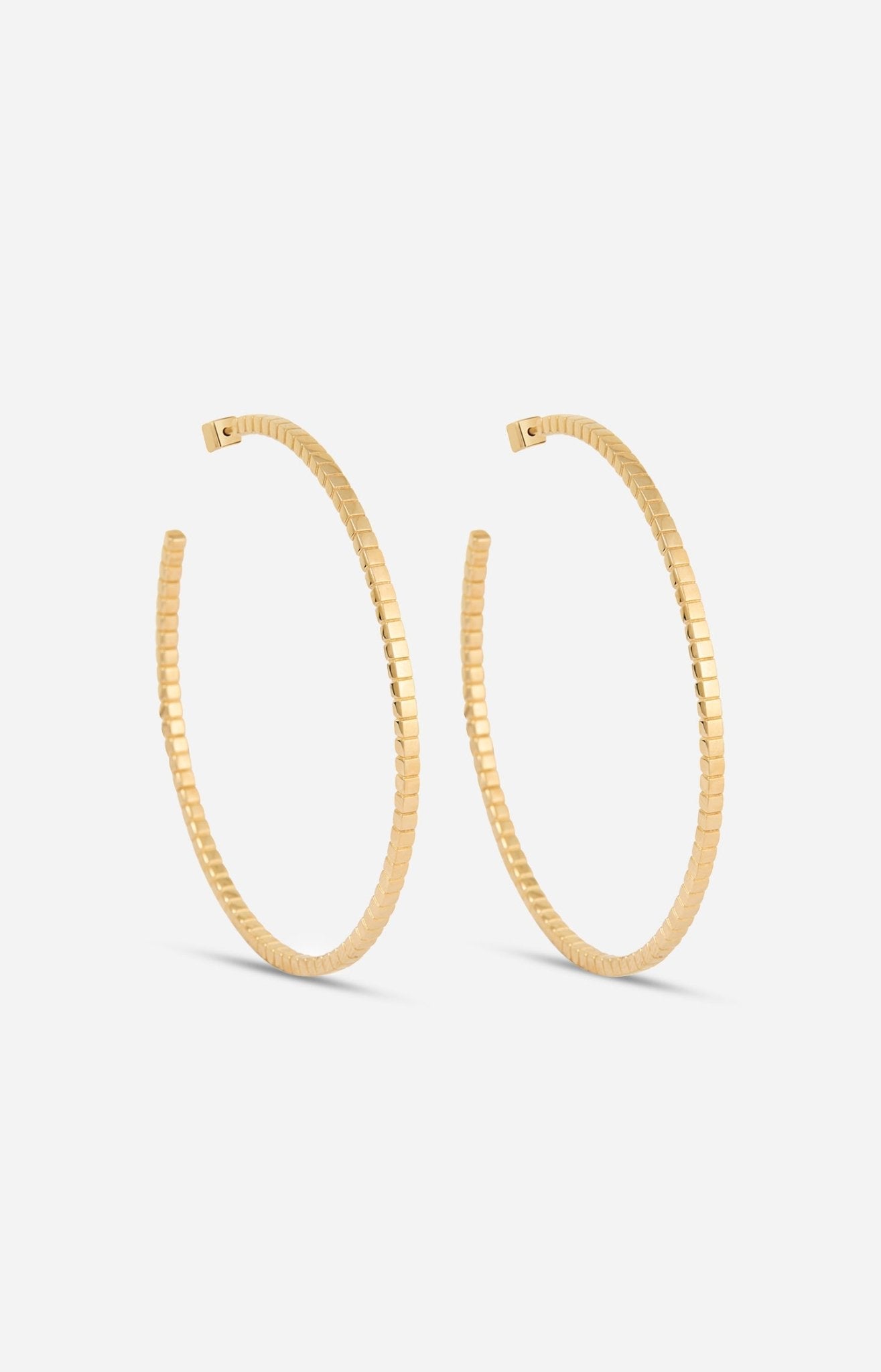 A pair of gold-plated Signore hoop earrings with a textured design, resembling a curving row of square beads.