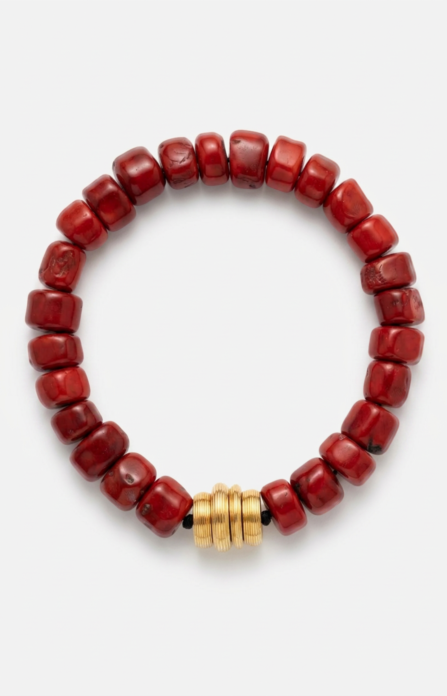Red coral beaded necklace with a gold clasp on a white background.