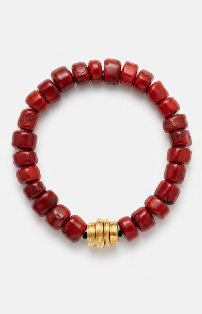 Red coral beaded necklace with a gold clasp on a white background.