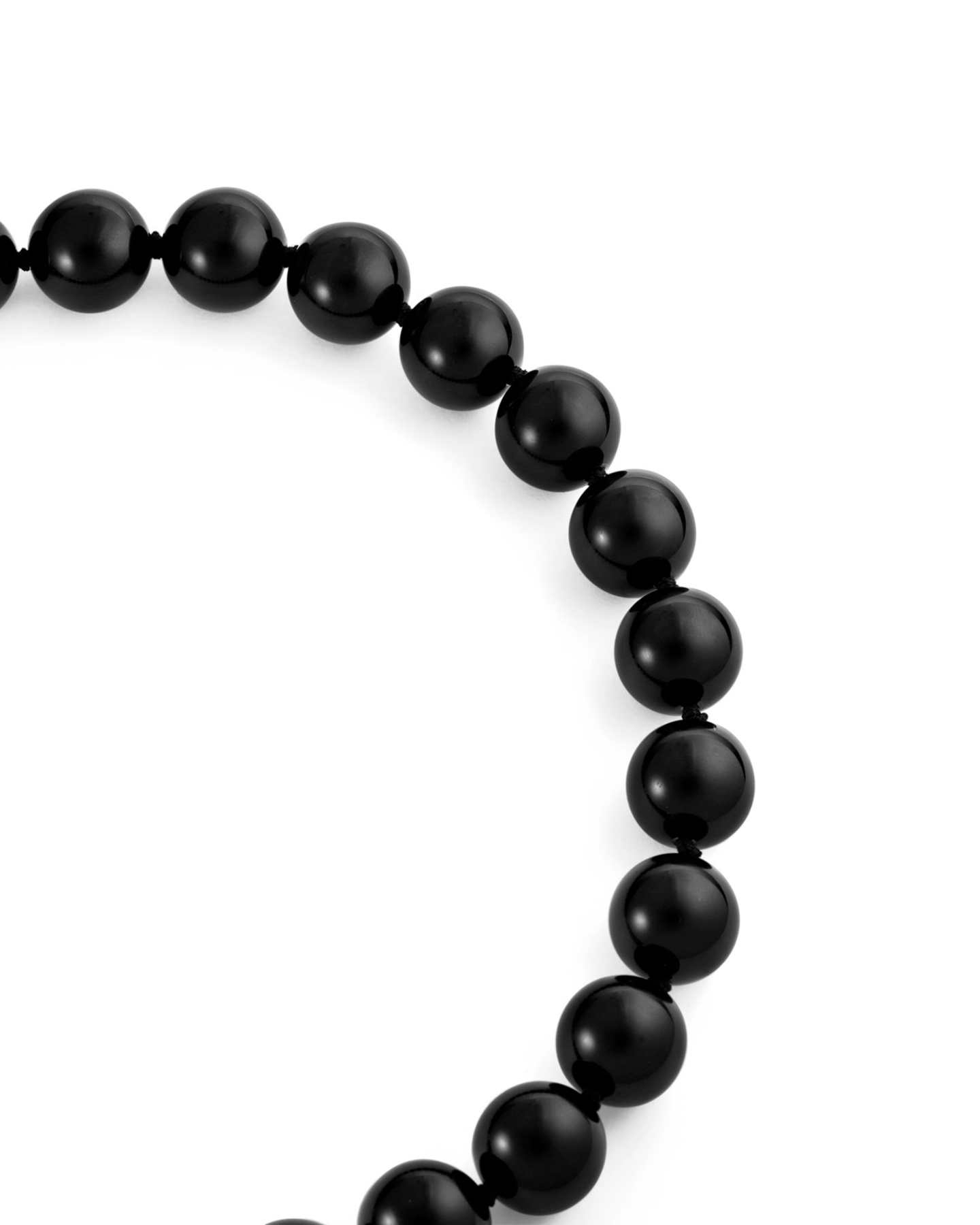 An onyx black beaded necklace on a white background.
