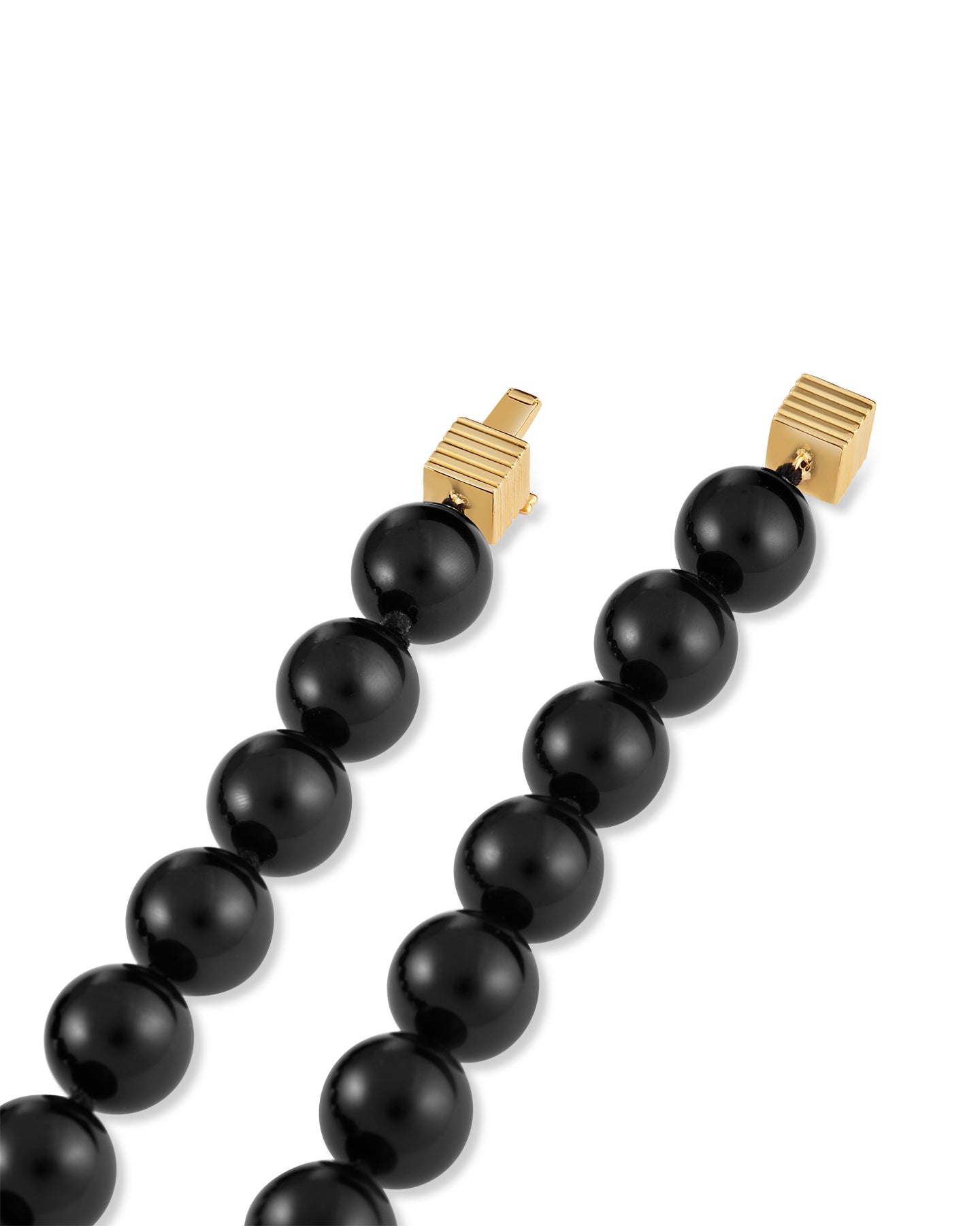 An onyx black beaded necklace with gold-plated clasp on a white background.