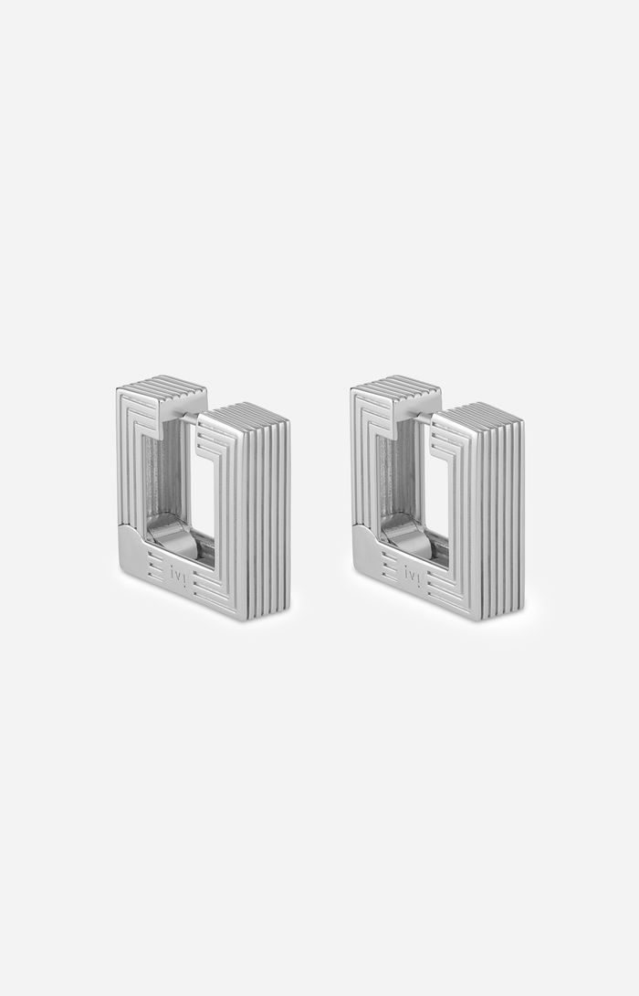 Pair of rhodium-plated medium Aurelia sculptural square hoop earrings on a white background.