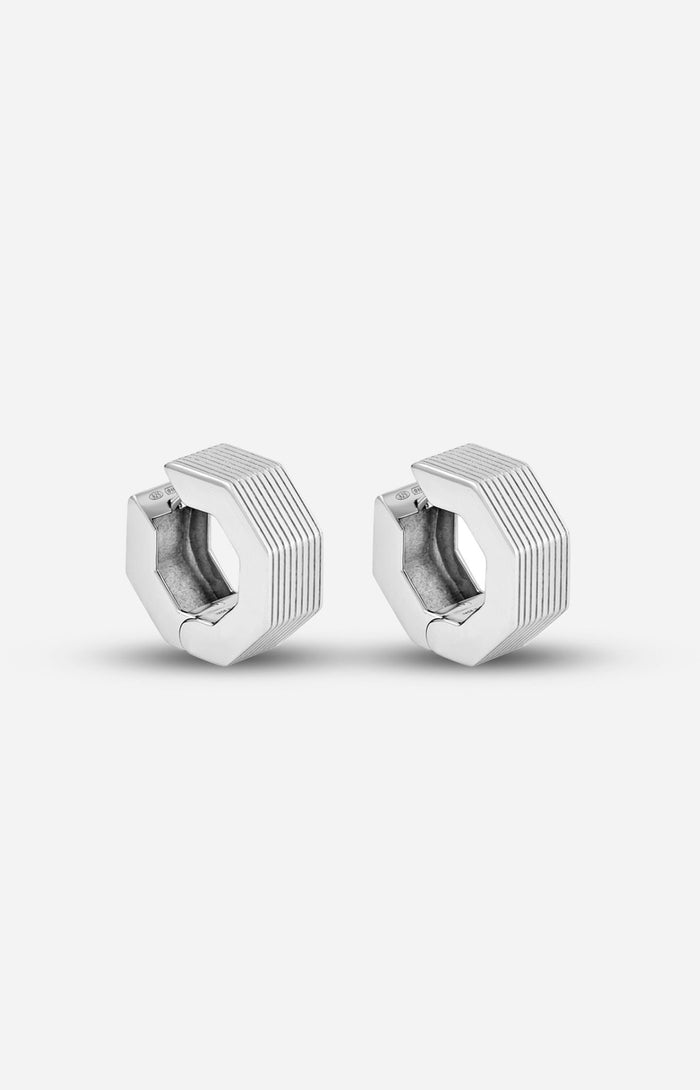 A pair of rhodium-plated medium-sized octagon hoop earrings with linear engravings.