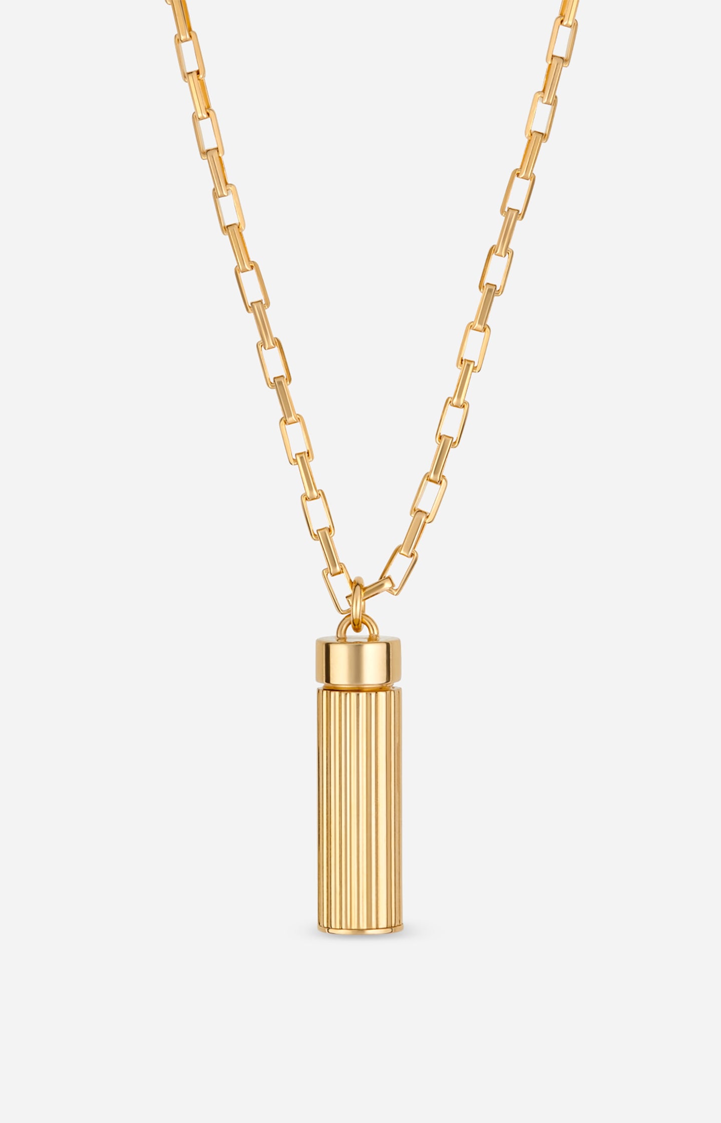 Gold necklace with a cylindrical pendant on a white background