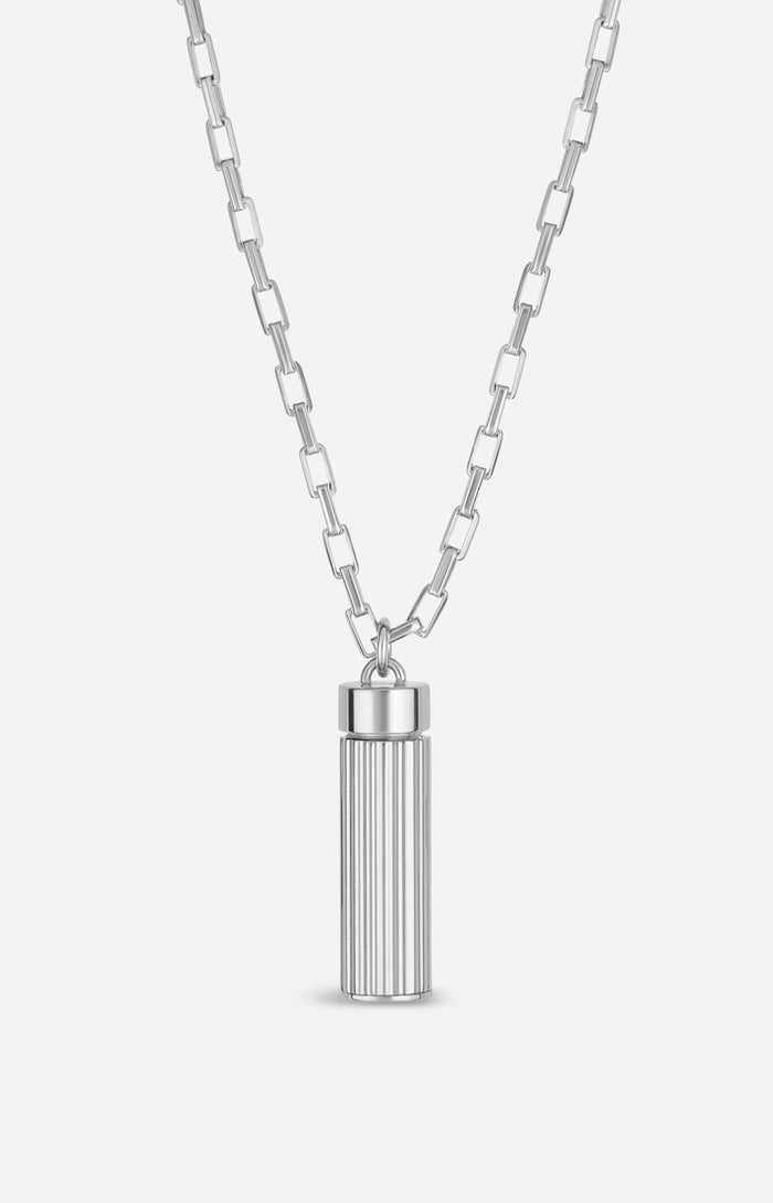 Silver necklace with a cylindrical pendant on a white background