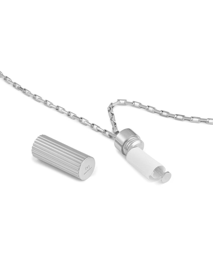 Silver pendant necklace with a ridged cylindrical charm, shown open to reveal a hidden paper insert on a silver chain.