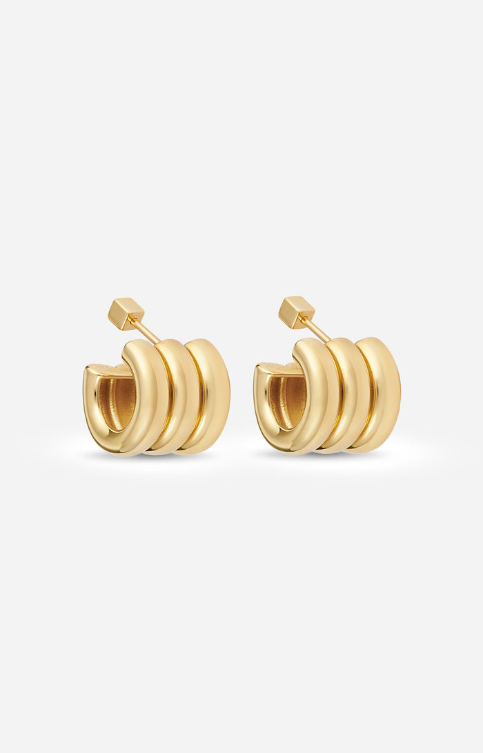 Pair of gold-plated Mini Gaia sculptural hoop earrings on a white background. 