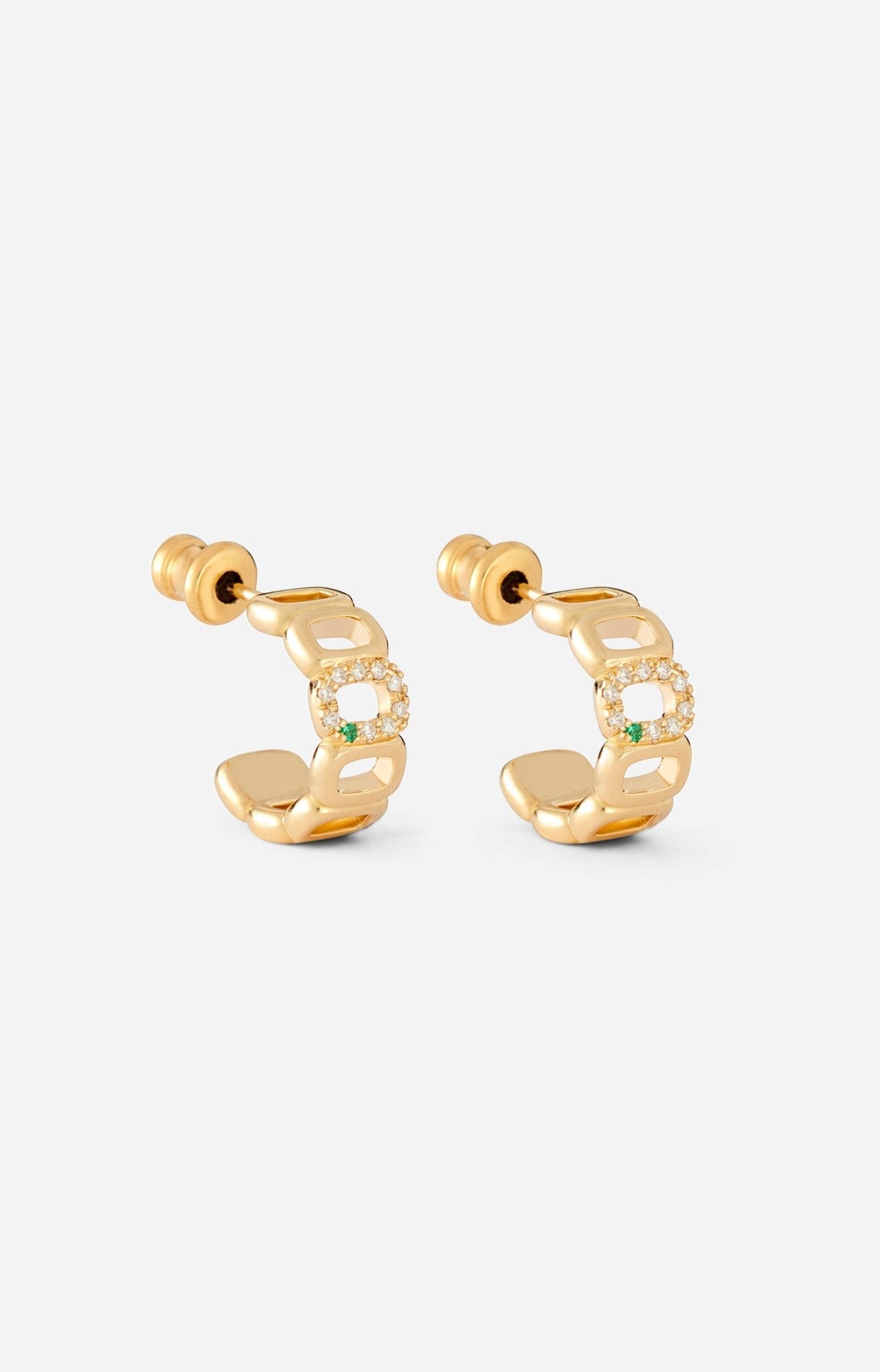 A pair of mini toy hoop earrings crafted from 18-karat gold, featuring oval links adorned with diamonds and an emerald.
