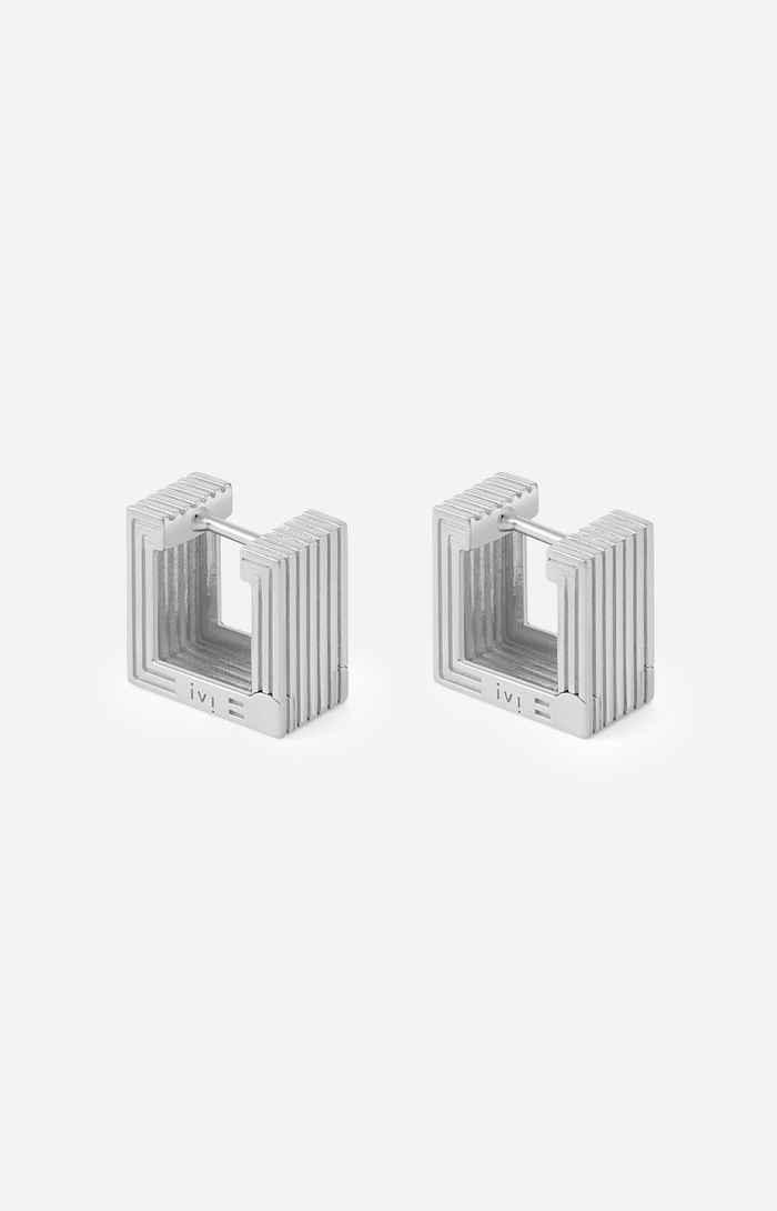Pair of rhodium-plated Mini Wide Aurelia sculptural square hoop earrings on a white background.