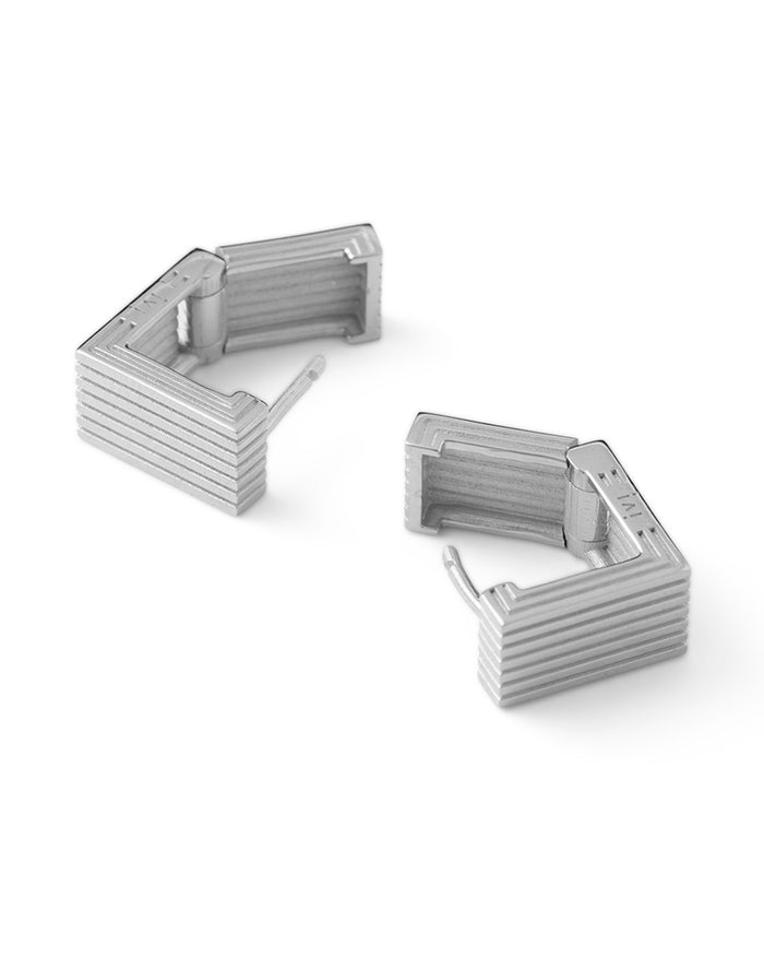 Pair of rhodium-plated Mini Wide Aurelia sculptural square hoop earrings on a white background.