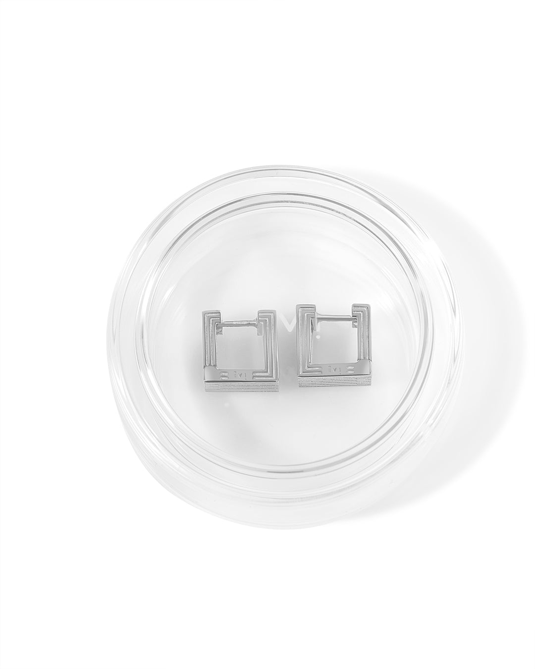 Pair of rhodium-plated Mini Wide Aurelia sculptural square hoop earrings in glass packaging