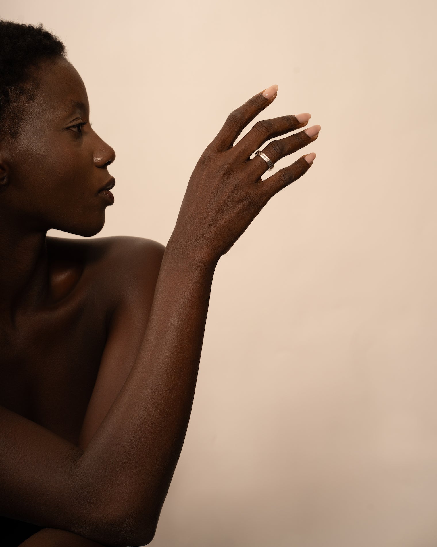 Hexagonal rhodium-plated ring worn by a model. 