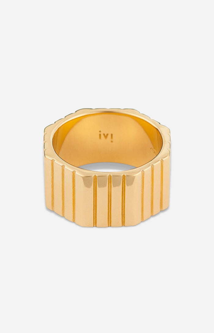 A gold-plated, octagonal-shaped ring with linear engravings on the band.