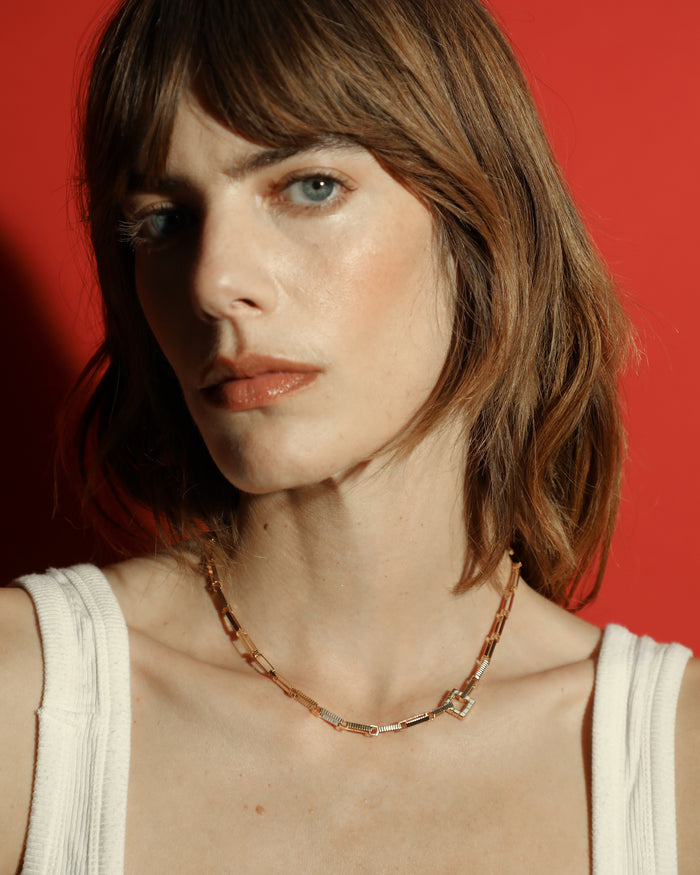 Gold-plated Signora Chain choker necklace with rectangular links and a signature square clasp, worn by a model. 