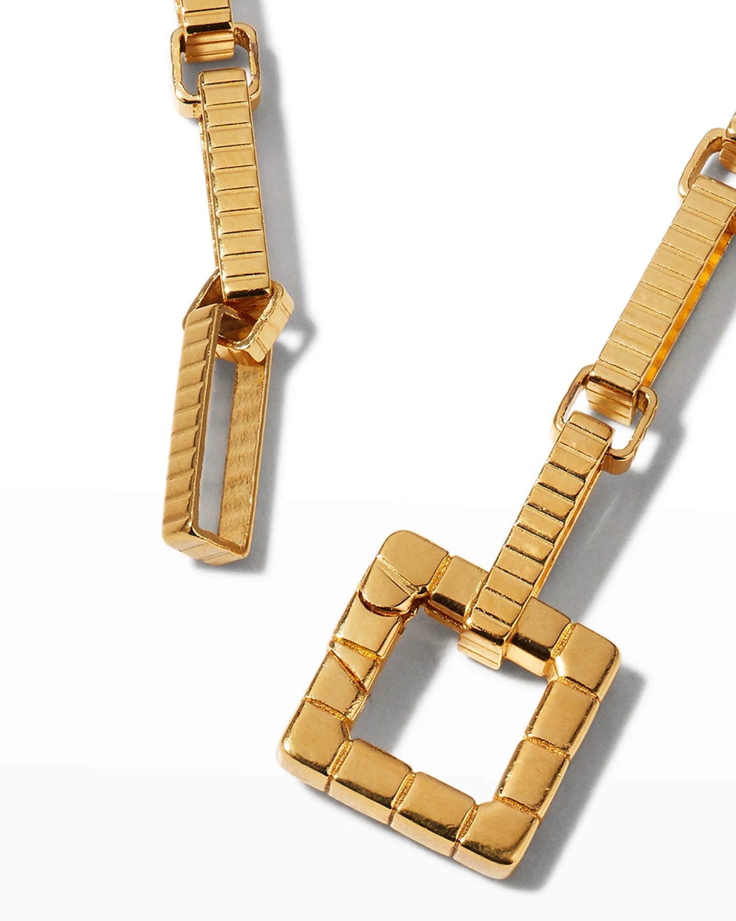 A close up of the signature square clasp, displayed on a white background.