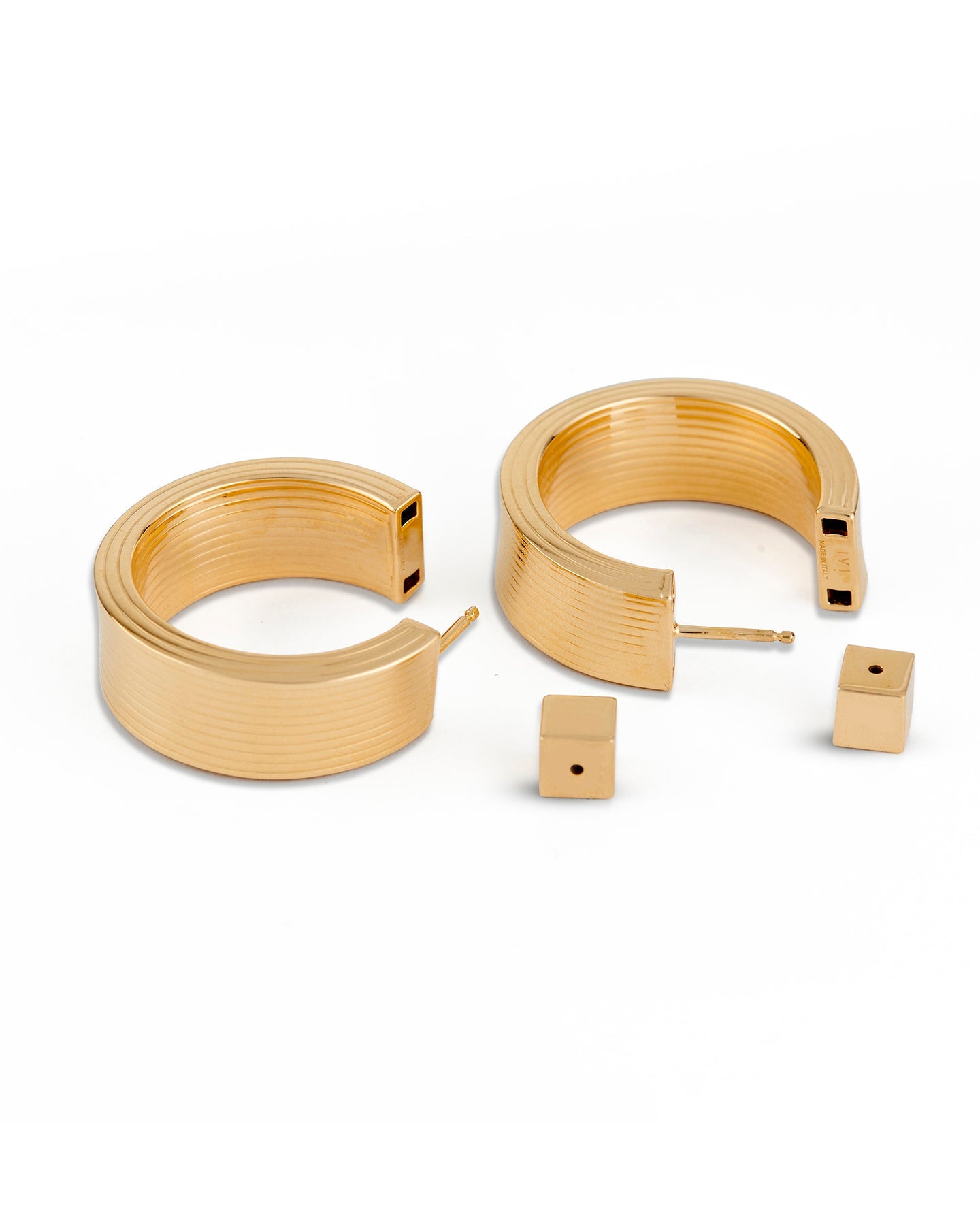 A pair of gold-plated hollow hoop earrings with a square post, displayed on a white background.