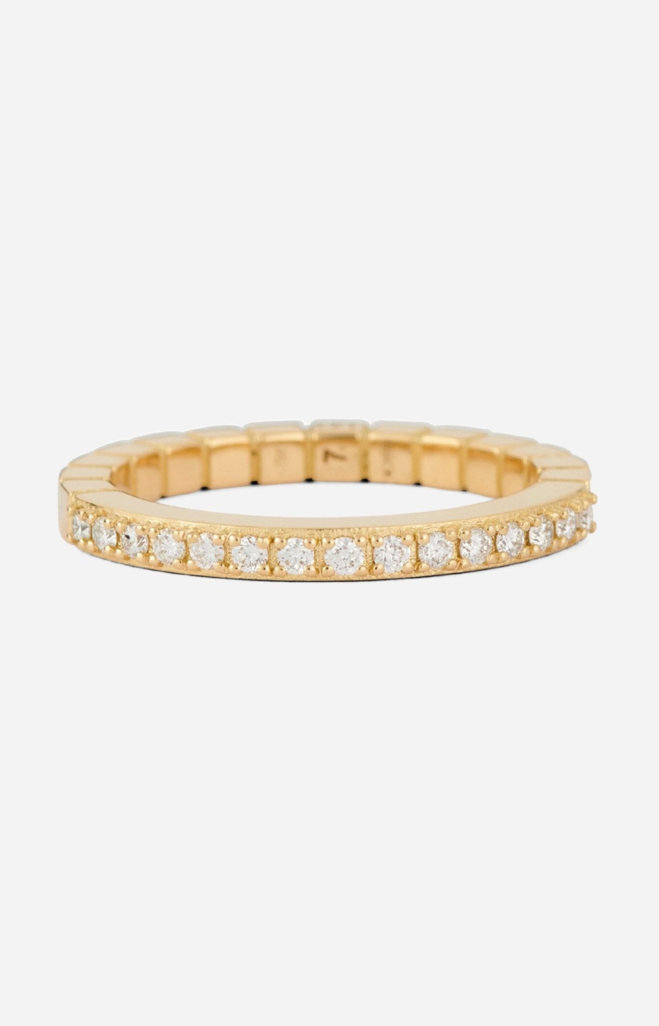 An 18-karat gold band ring with round-cut diamonds set on a white background.