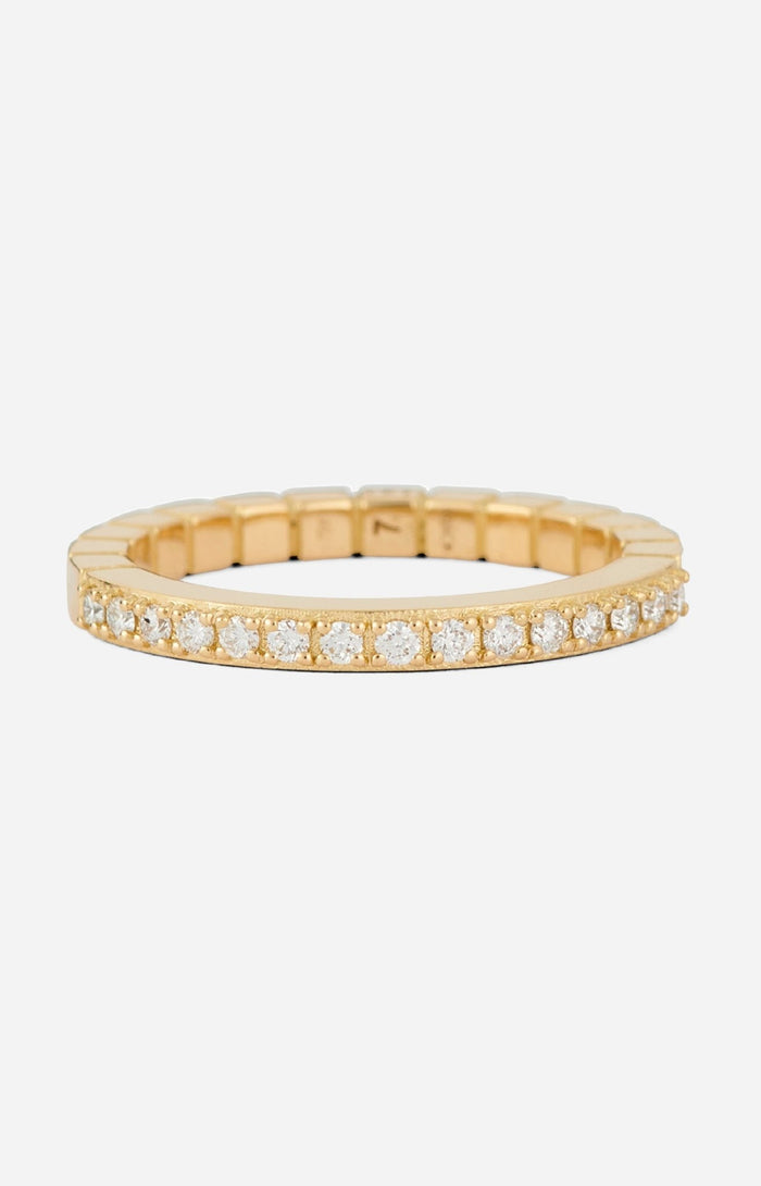An 18-karat gold band ring with round-cut diamonds set on a white background.